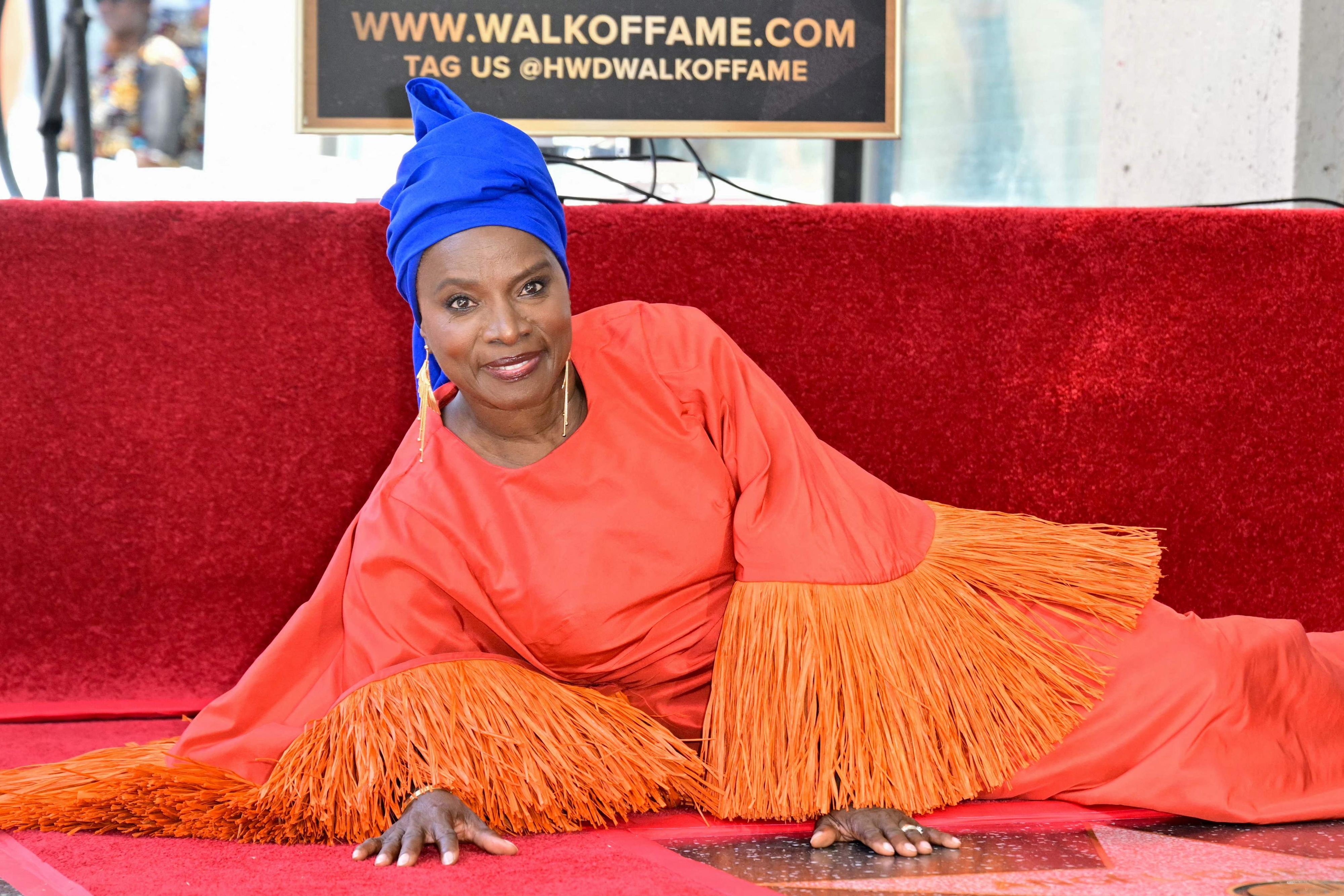 Beninese musician and actress Angelique Kidjo poses next to her newly unveiled star during her Hollywood Walk of Fame star ceremony in the Hollywood neighborhood of Los Angeles on August 18, 2026. (Photo by Frederic J. Brown / AFP)