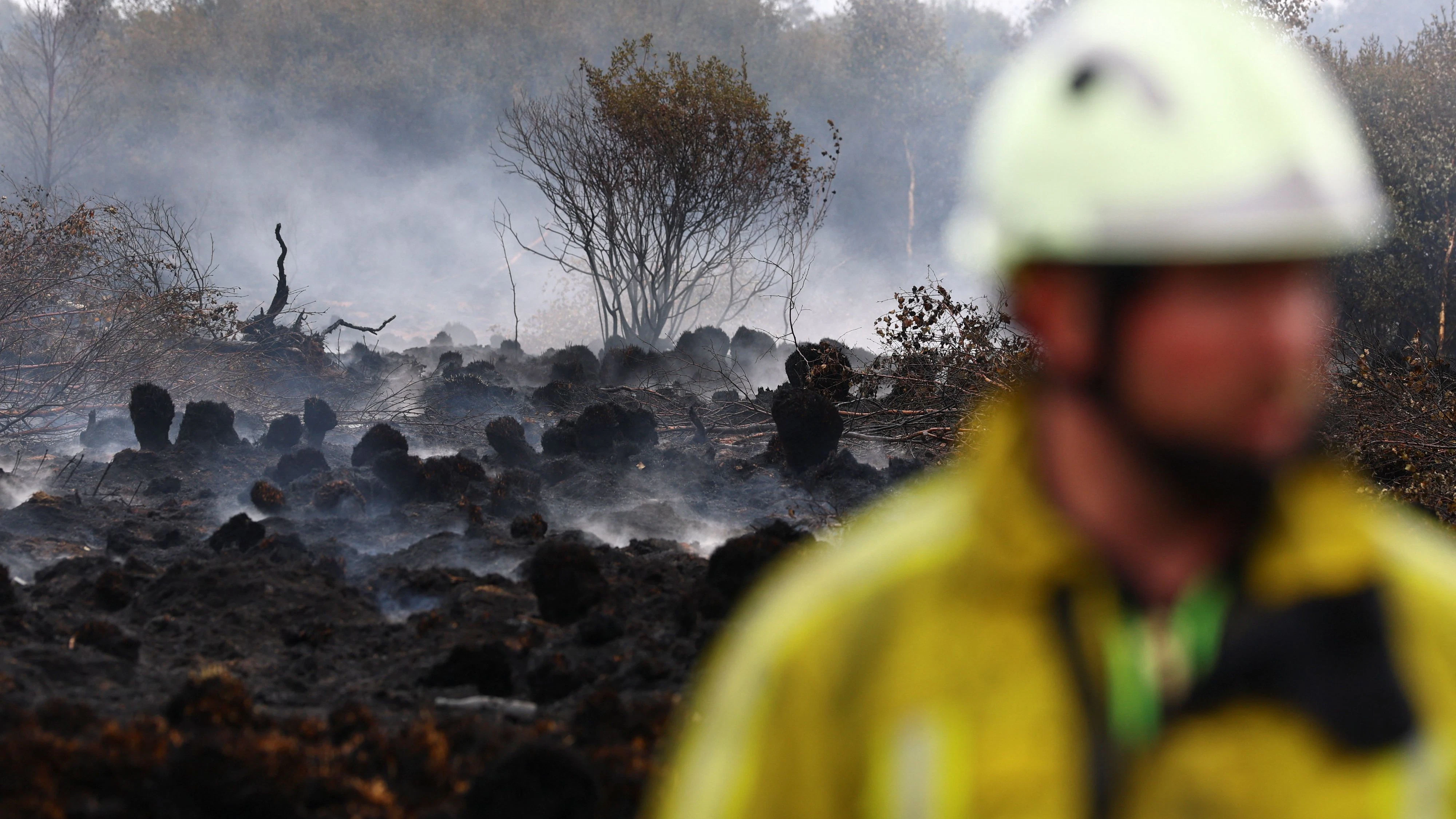 A Belgian firefighter in a field affected by a wildfire in Waimes, in the High Fens (Hautes Fagnes) region, Belgium, August 18, 2026. REUTERS/Yves Herman
