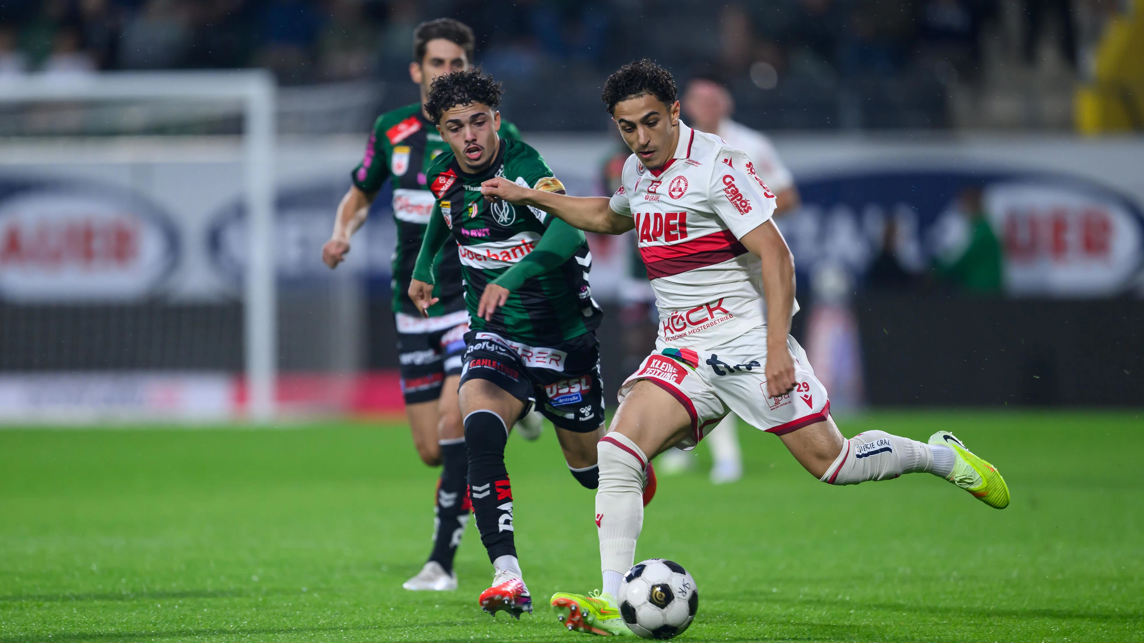 RIED,AUSTRIA,21.AUG.26 - SOCCER - ADMIRAL Bundesliga, SV Ried vs Grazer AK 1902. Image shows Ismael Guerti (GAK) and Jussuf Nasrawe (Ried). Photo: GEPA pictures/ Christian Moser
