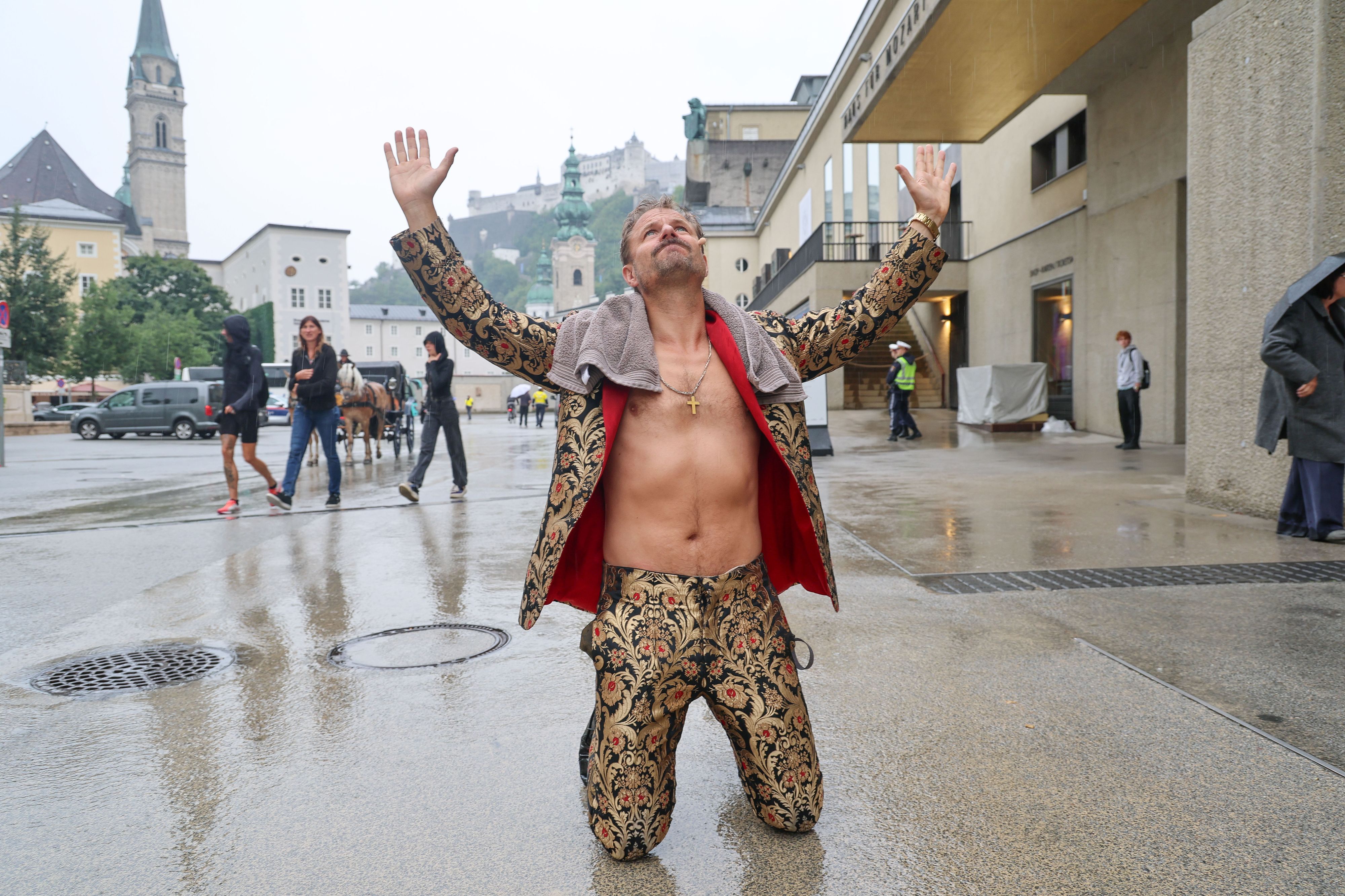 Philipp Hochmair im Jedermann Outfit im Regen vor dem Festspielhaus