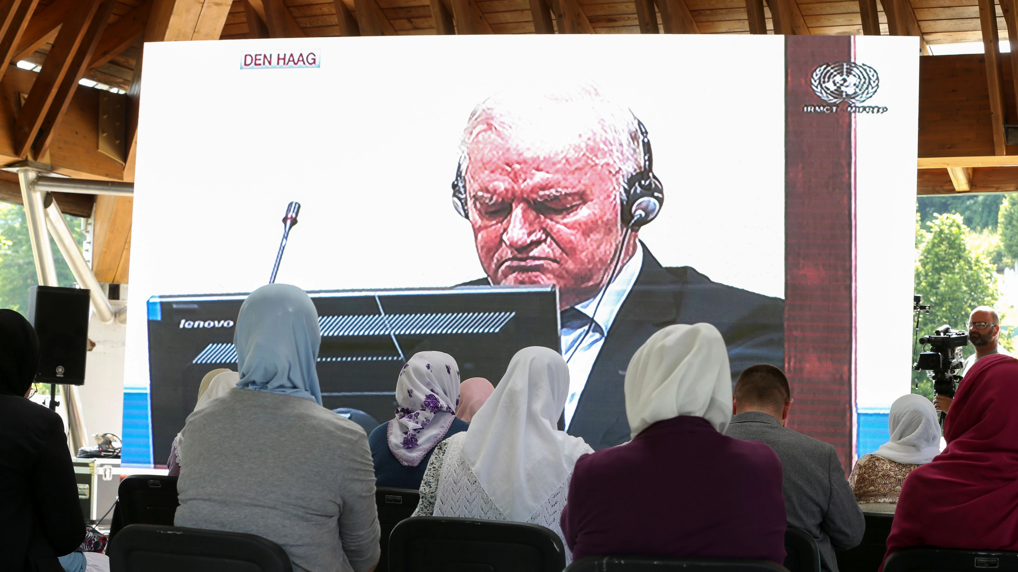 Bosnian Muslim women watch a television broadcast of the final verdict of former Bosnian Serb military leader Ratko Mladic, in the Srebrenica-Potocari Genocide Memorial Center, Bosnia and Herzegovina, June 8, 2021. REUTERS/Dado Ruvic