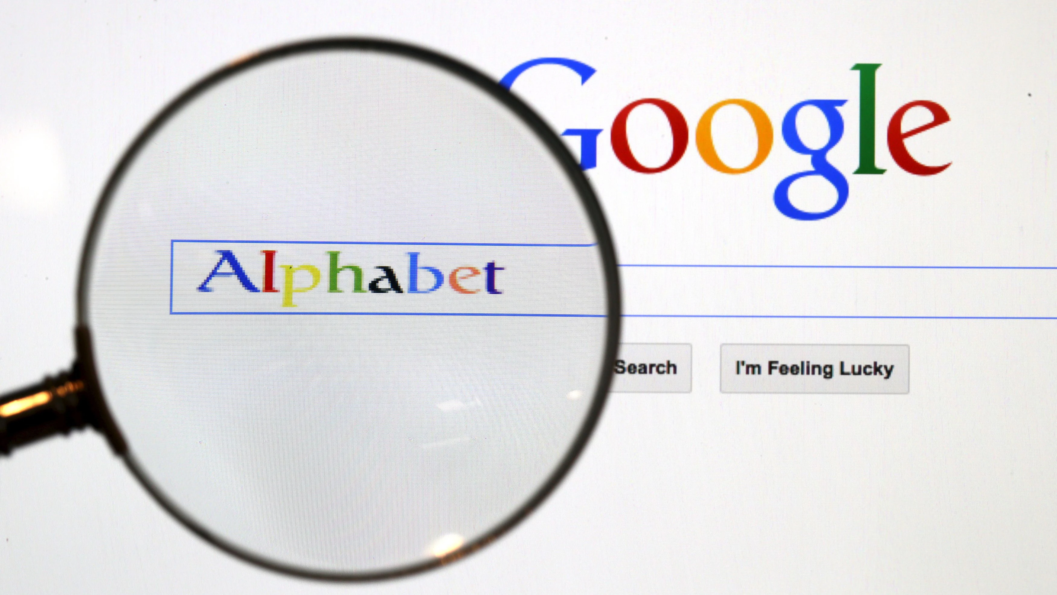 A Google search page is seen through a magnifying glass in this photo illustration taken in Berlin, August 11, 2015.  A U.S. Jury handed Google a major victory May 26, 2016 in a long-running copyright battle with Oracle Corp over Android software to run most of the world's smartphones. This logo has been updated and is no longer in use.  REUTERS/Pawel Kopczynski/Files