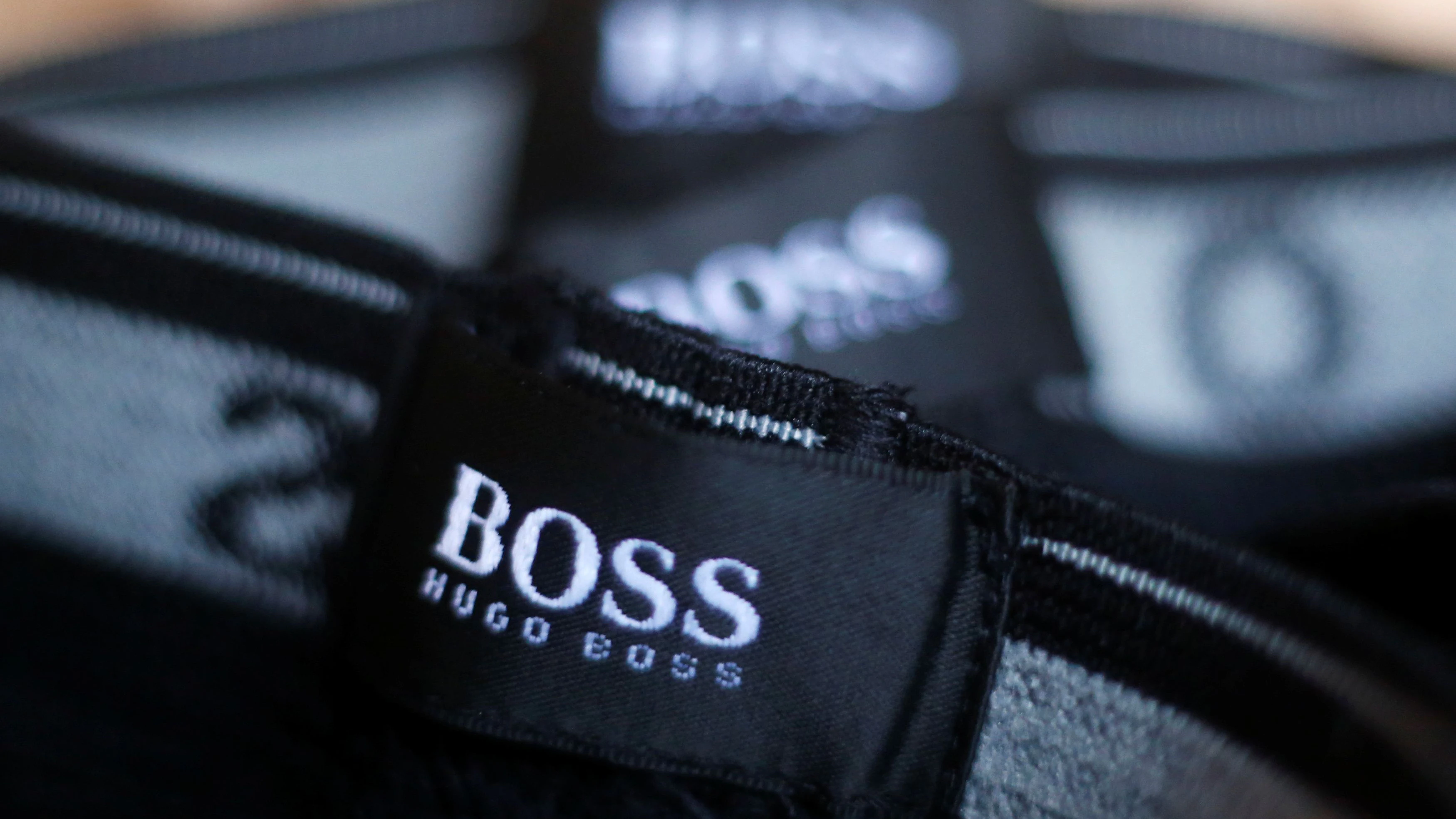 The logo of German fashion house Hugo Boss is seen on a clothing label at their outlet store in Mezingen near Stuttgart October 29, 2013.  REUTERS/Michael Dalder/File Photo                 GLOBAL BUSINESS WEEK AHEAD PACKAGE - SEARCH 'BUSINESS WEEK AHEAD 31 OCT'  FOR ALL IMAGES