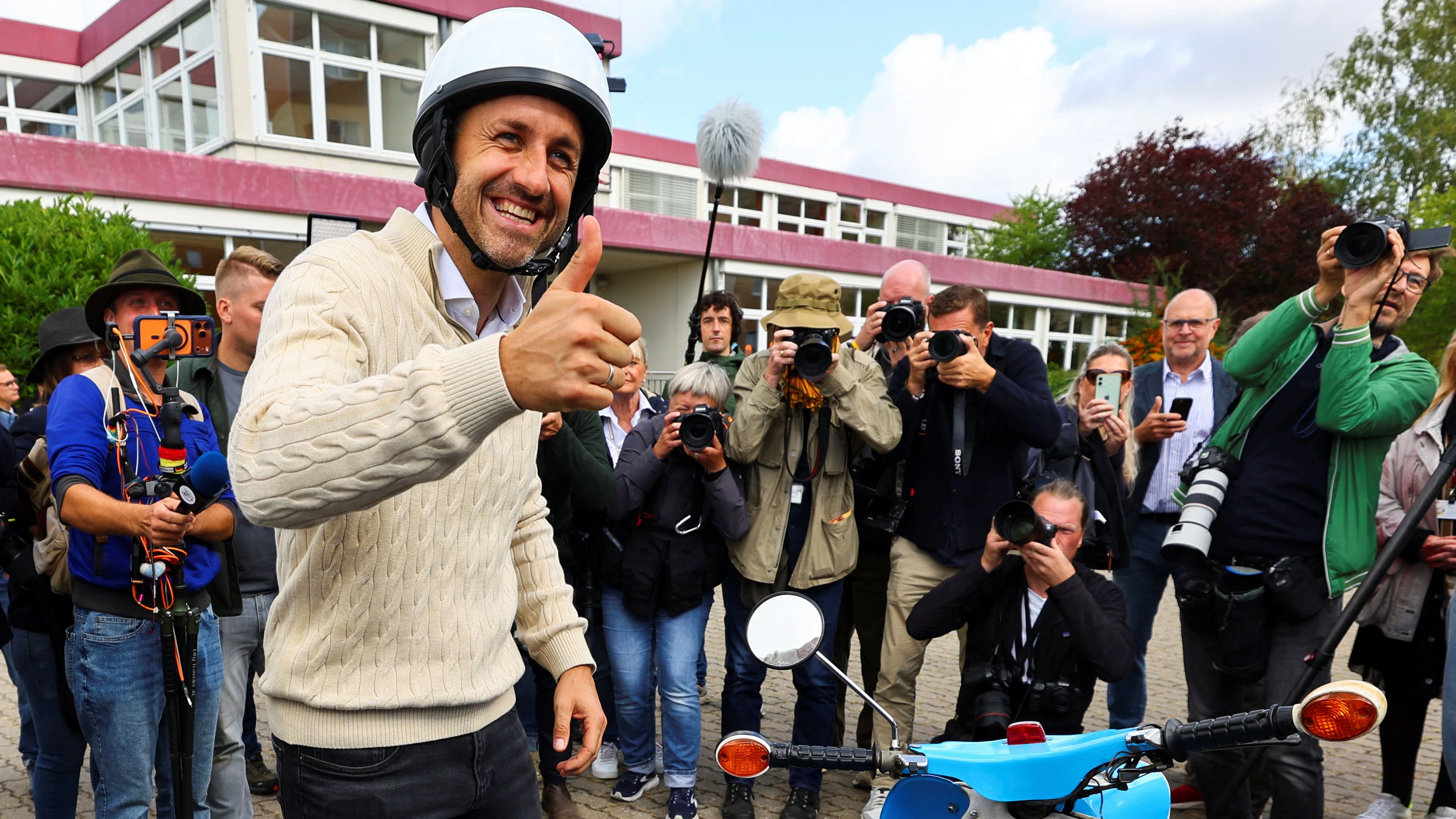 Top candidate of the far-right Alternative for Germany (AfD), Ulrich Siegmund, gestures next to the scooter he arrived on, after voting in the Saxony-Anhalt state election, in Tangermuende, Germany, September 6, 2026.    REUTERS/Fabrizio Bensch 
