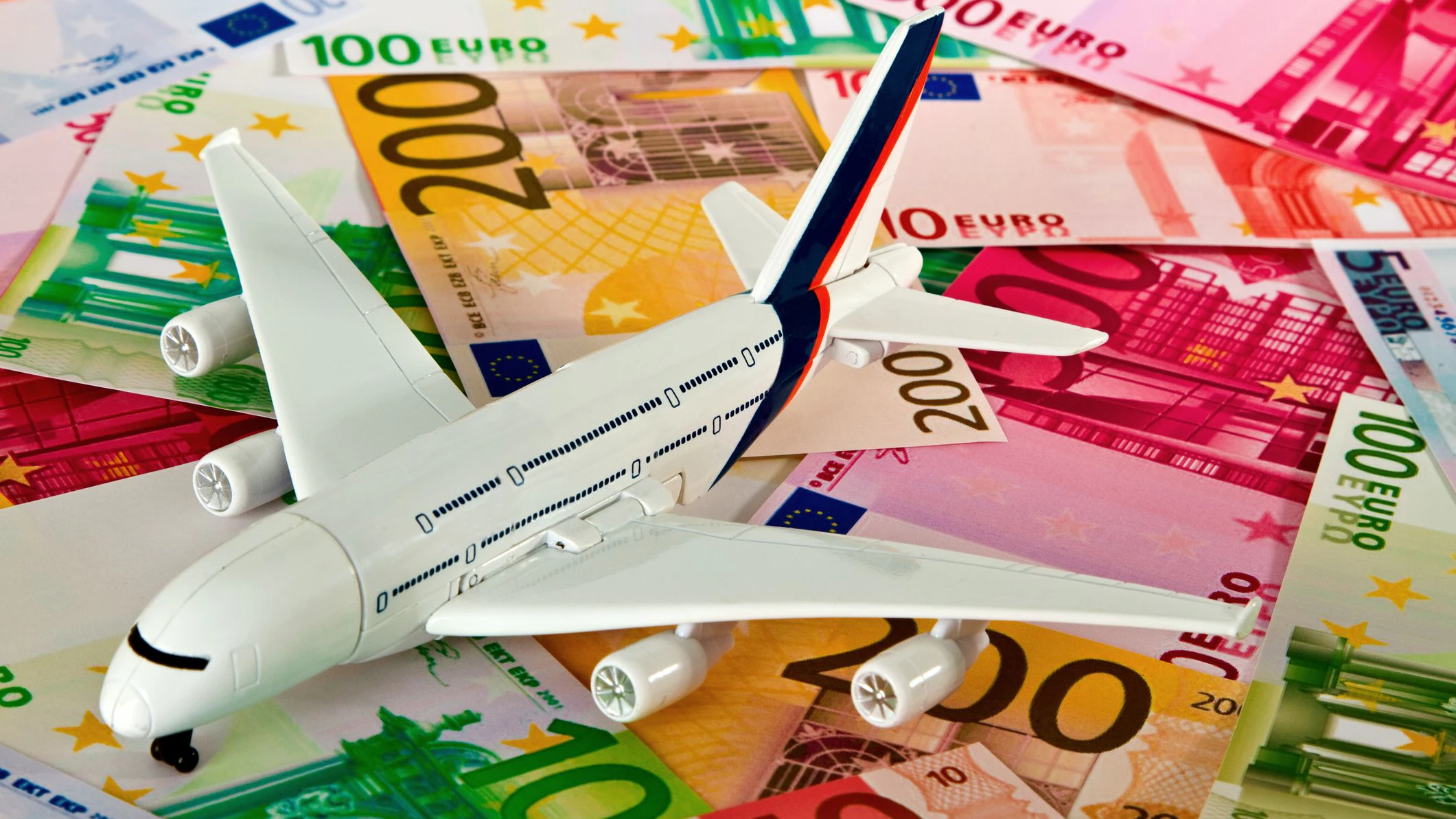 Euro banknotes with model arilplane. Studio shot.