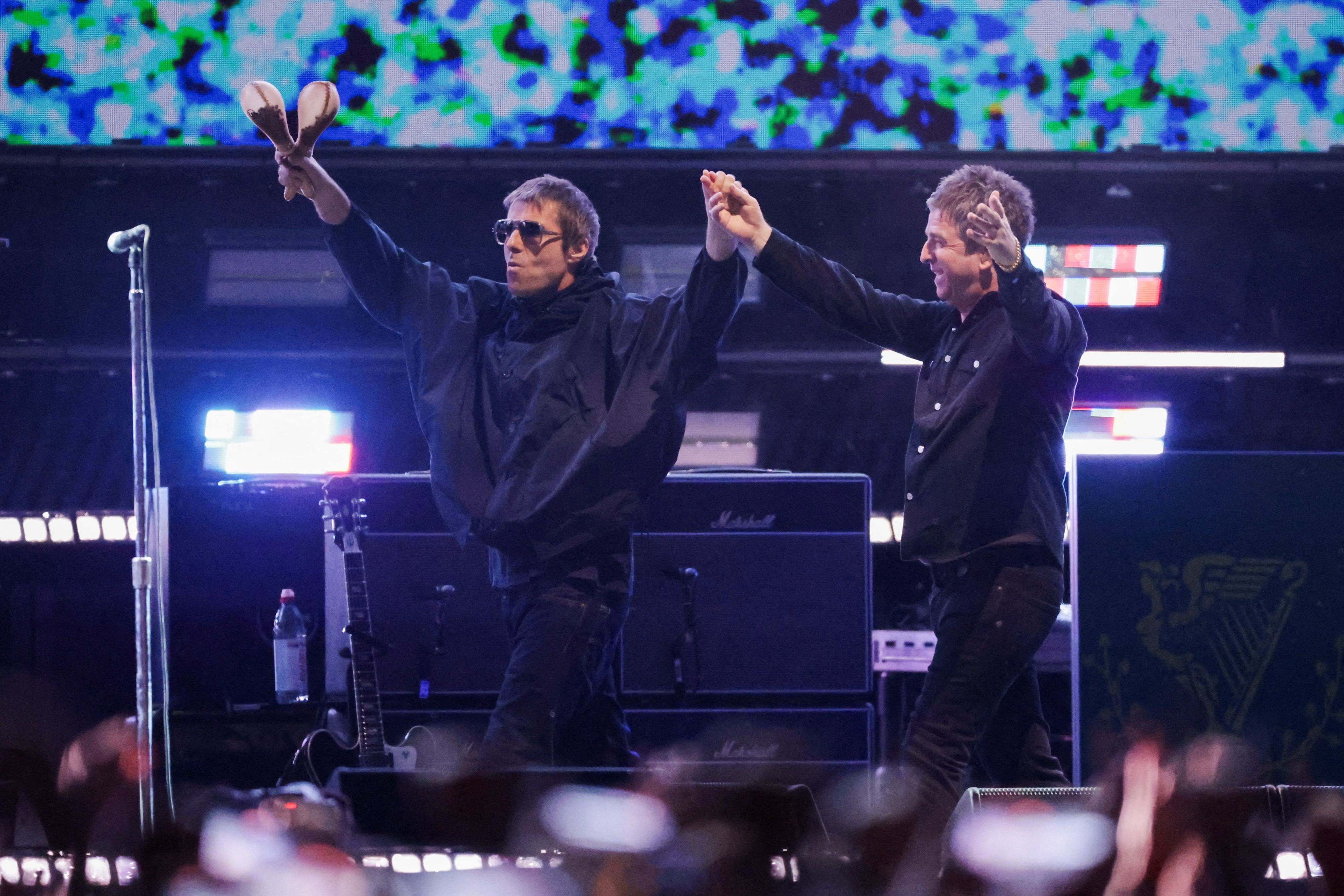 Liam Gallagher and Noel Gallagher from the British rock band Oasis, react during their Oasis Live '25 Tour at the Rose Bowl Stadium in Pasadena, California, U.S., September 6, 2025. REUTERS/Mario Anzuoni