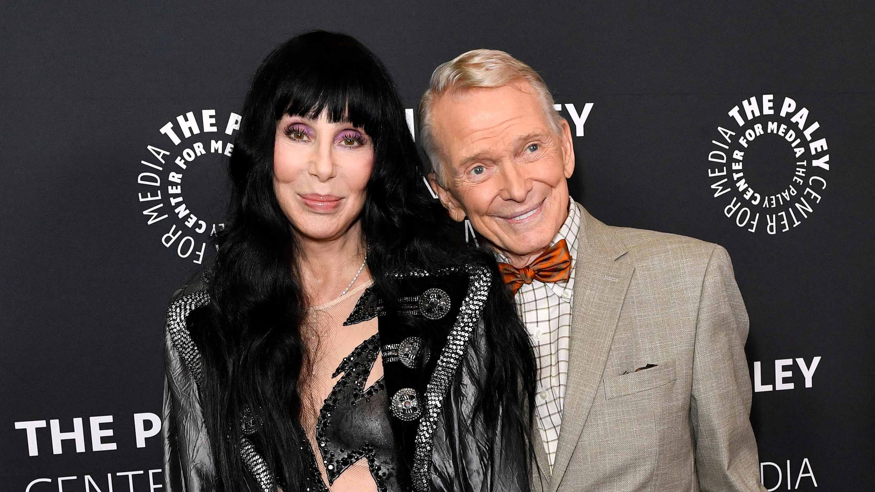 US singer and actress Cher (L) and US fashion designer Bob Mackie attend the premiere of "Bob Mackie: Naked Illusion" at the Directors Guild of America in Los Angeles, on May 13, 2024. (Photo by VALERIE MACON / AFP)