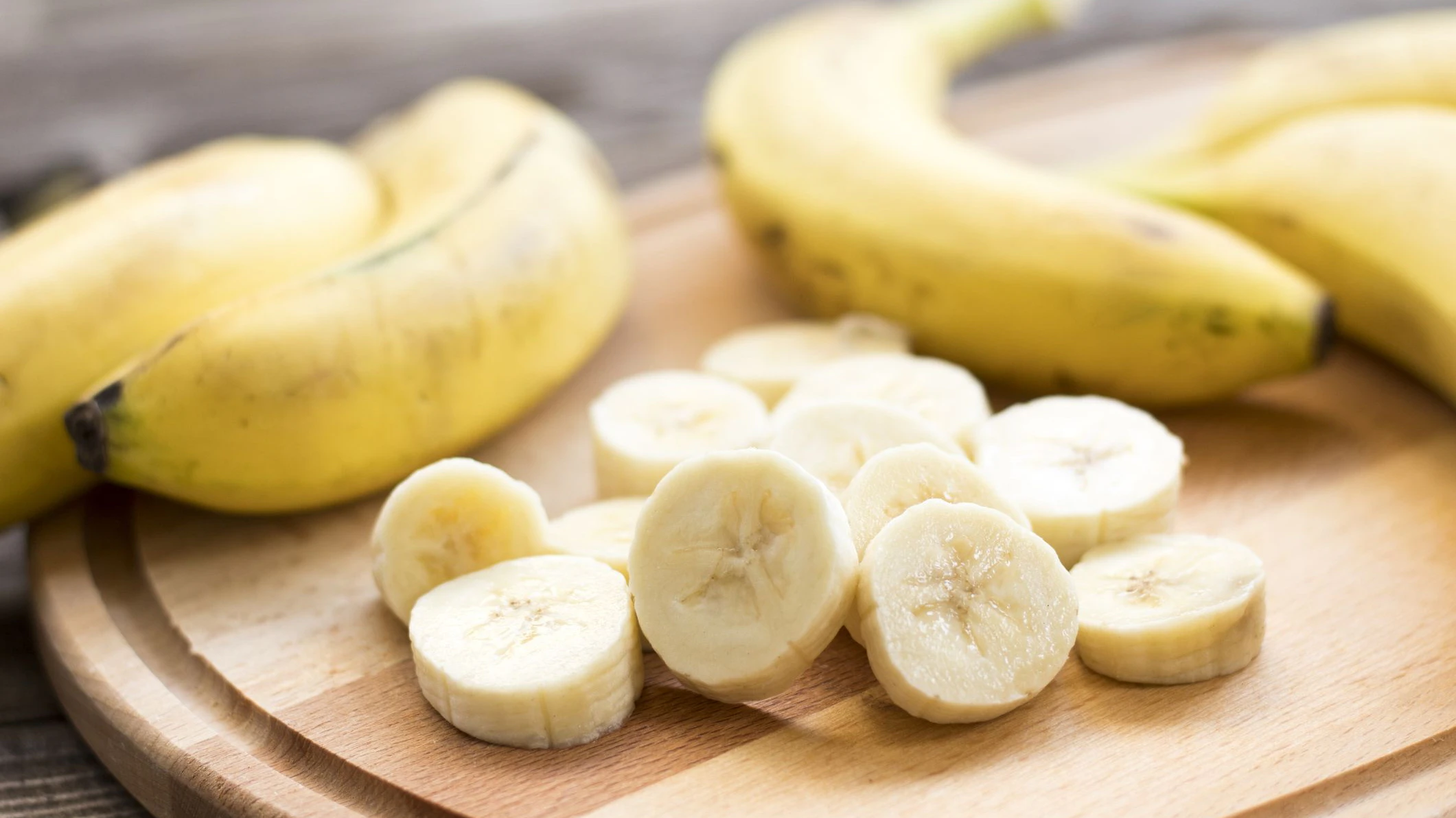 Fresh bananas on wooden background.