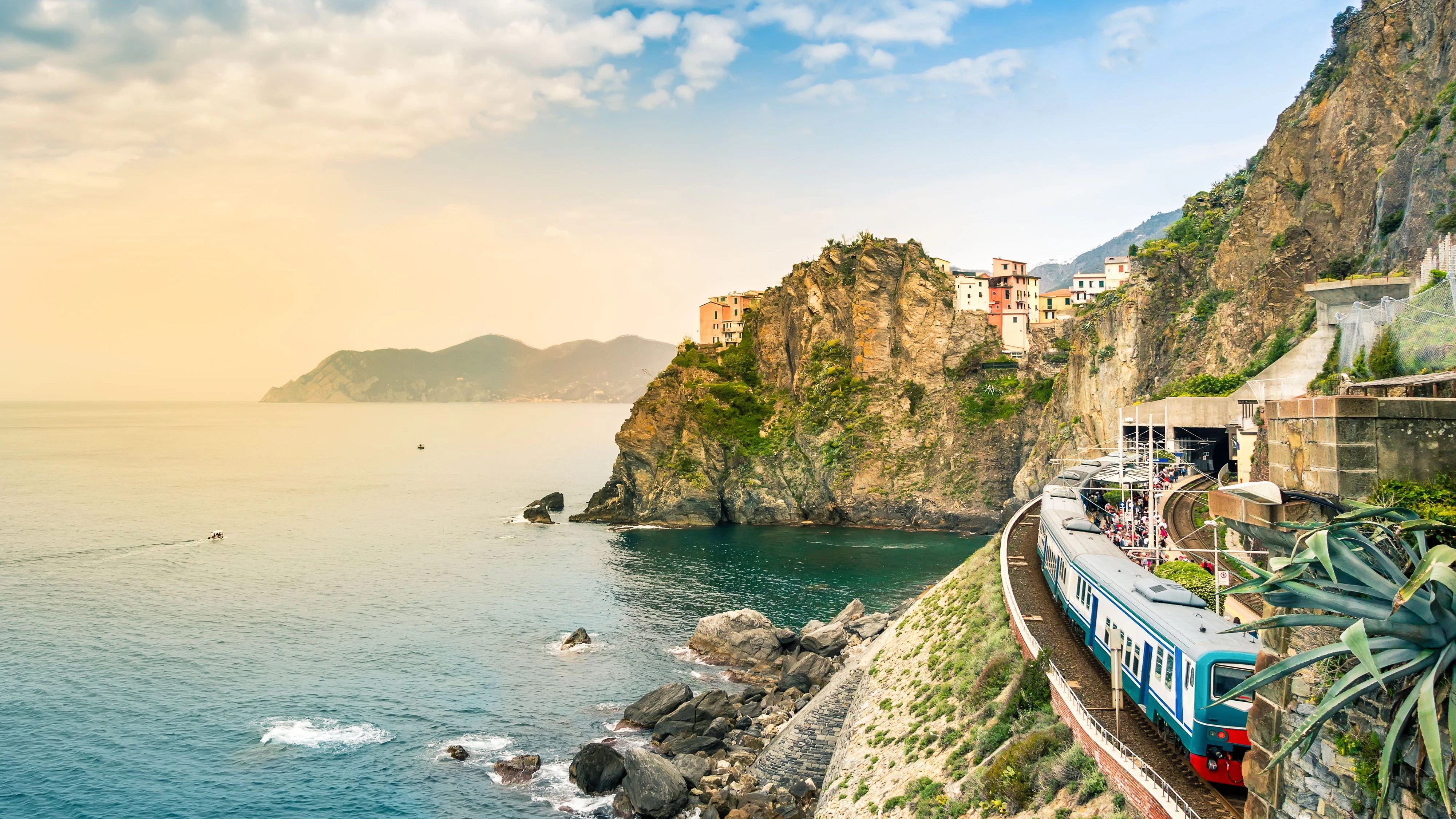 Manarola, Cinque Terre - train station in small village with colorful houses on cliff overlooking sea. Cinque Terre National Park with rugged coastline is famous tourist destination in Liguria, Italy