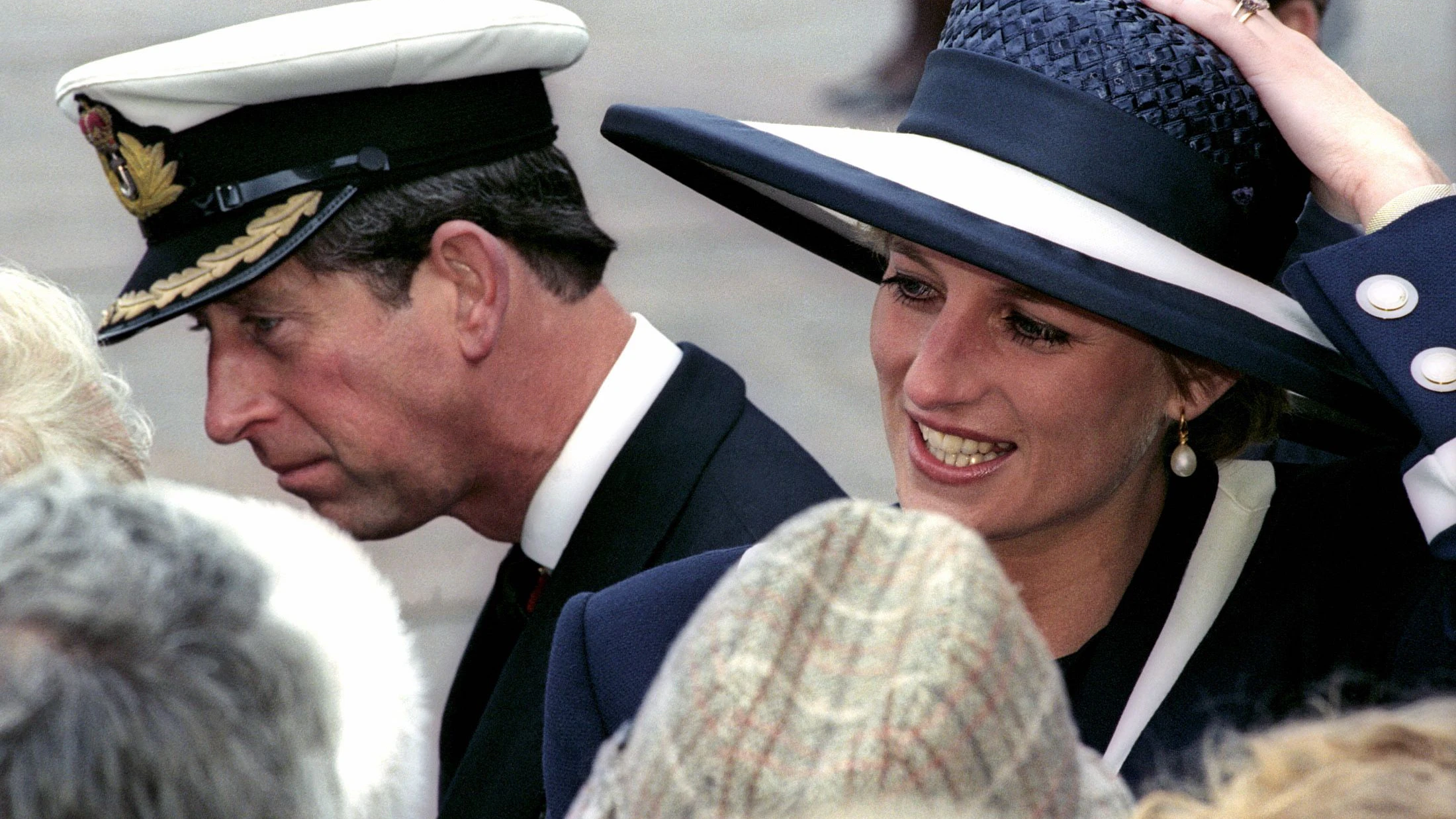 Britain's Prince Charles and Diana, Princess of Wales, chat to second world war veterans after a commemoration service in Liverpool to mark the 50th anniversary of the Battle of the Atlantic, May 30, 1993. This was one of the first times the couple had been seen together in public since their separation.  REUTERS/Bob Collier (BRITAIN)