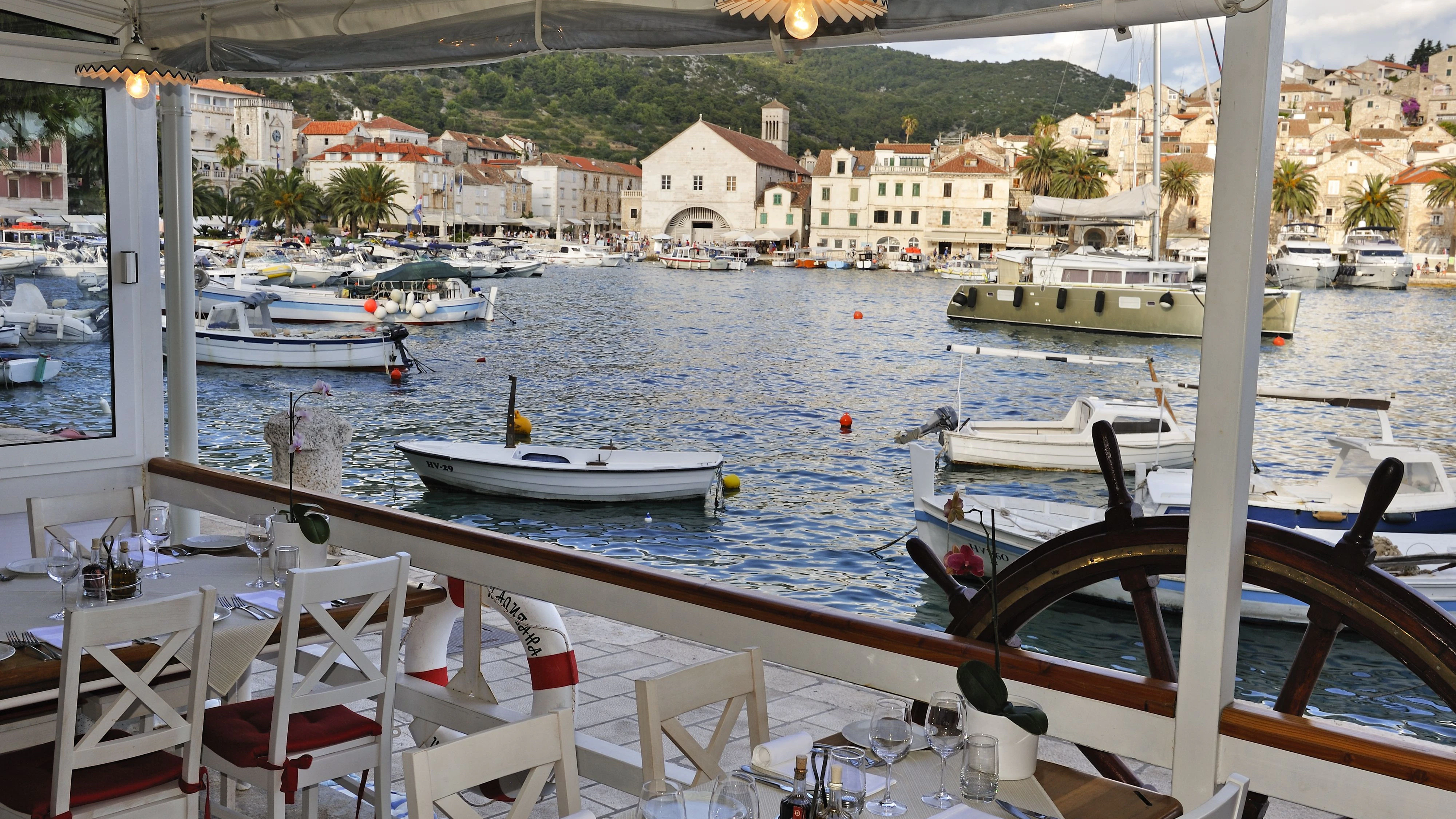terrace of the restaurant Kod Kapetana with view over the harbor of Hvar city, Hvar island, Croatia, Southeast Europe