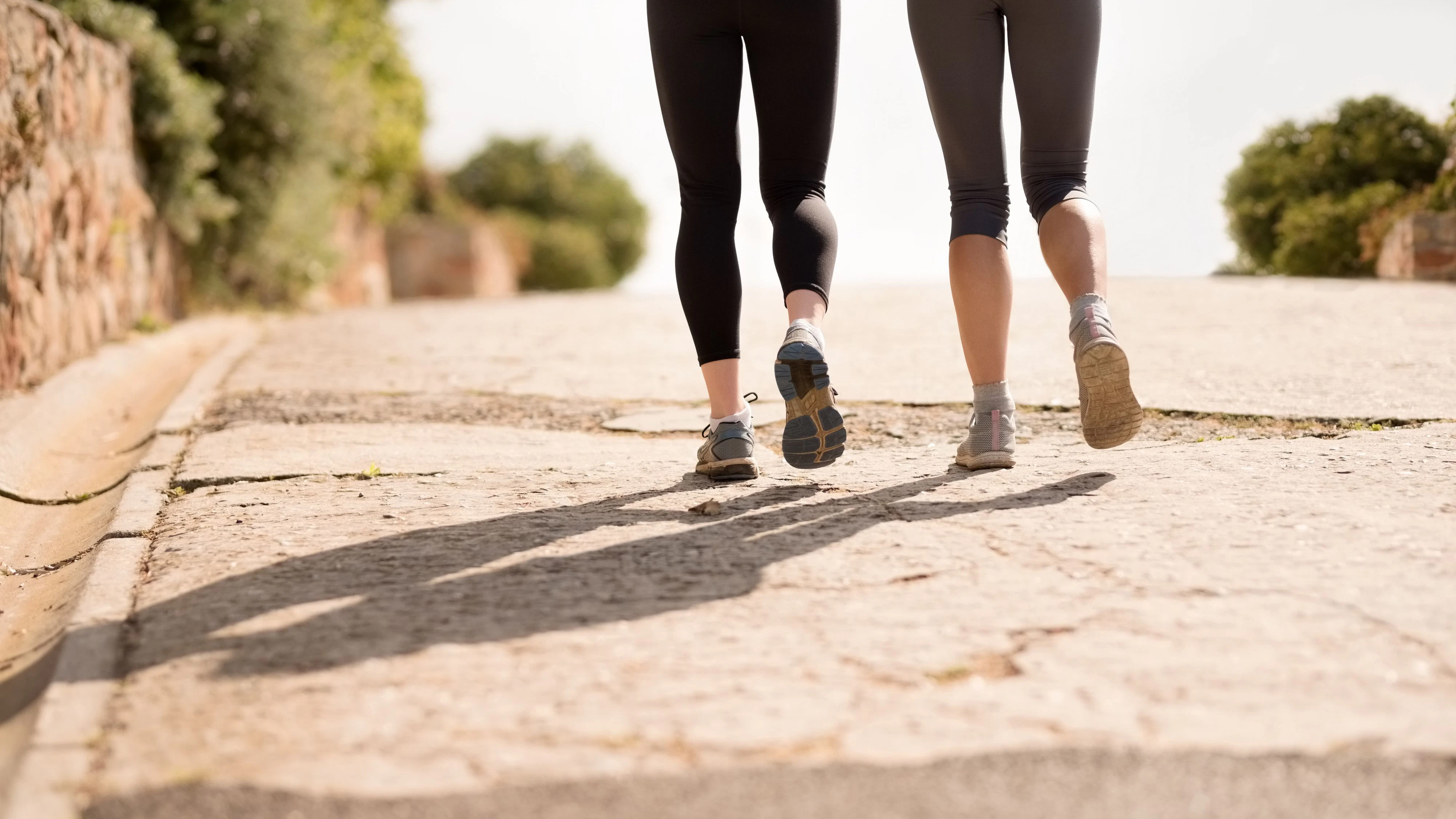 Low section shot of two female legs jogging outdoors