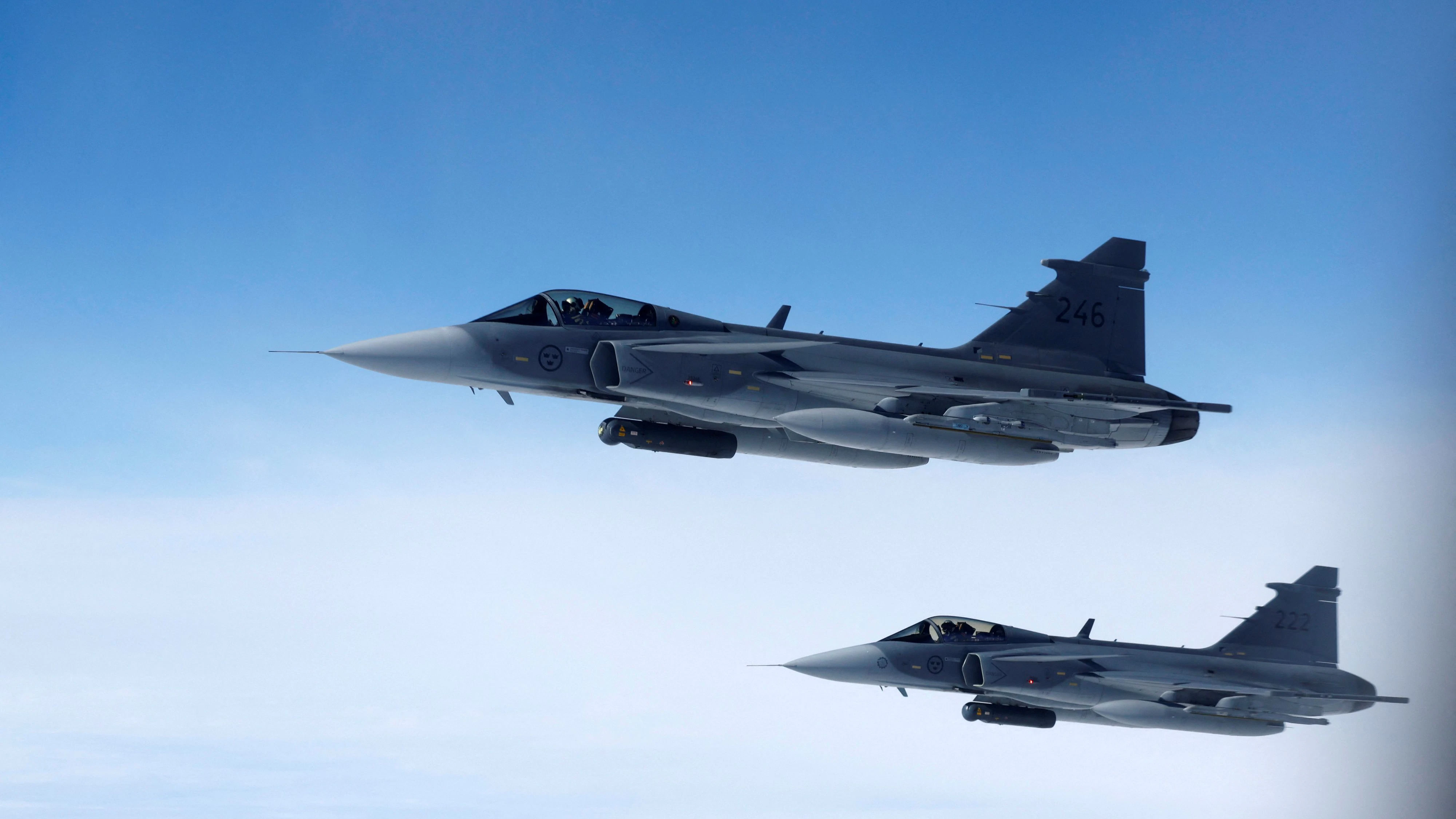 Swedish Air Force Saab JAS 39 Gripen fighter jets fly alongside an aircraft simulating aerial interceptions, during a media day illustrating how NATO Air Policing safeguards the Allies' airspace in the northern and northeastern region of the Alliance, July 4, 2023. REUTERS/Piroschka van de Wouw