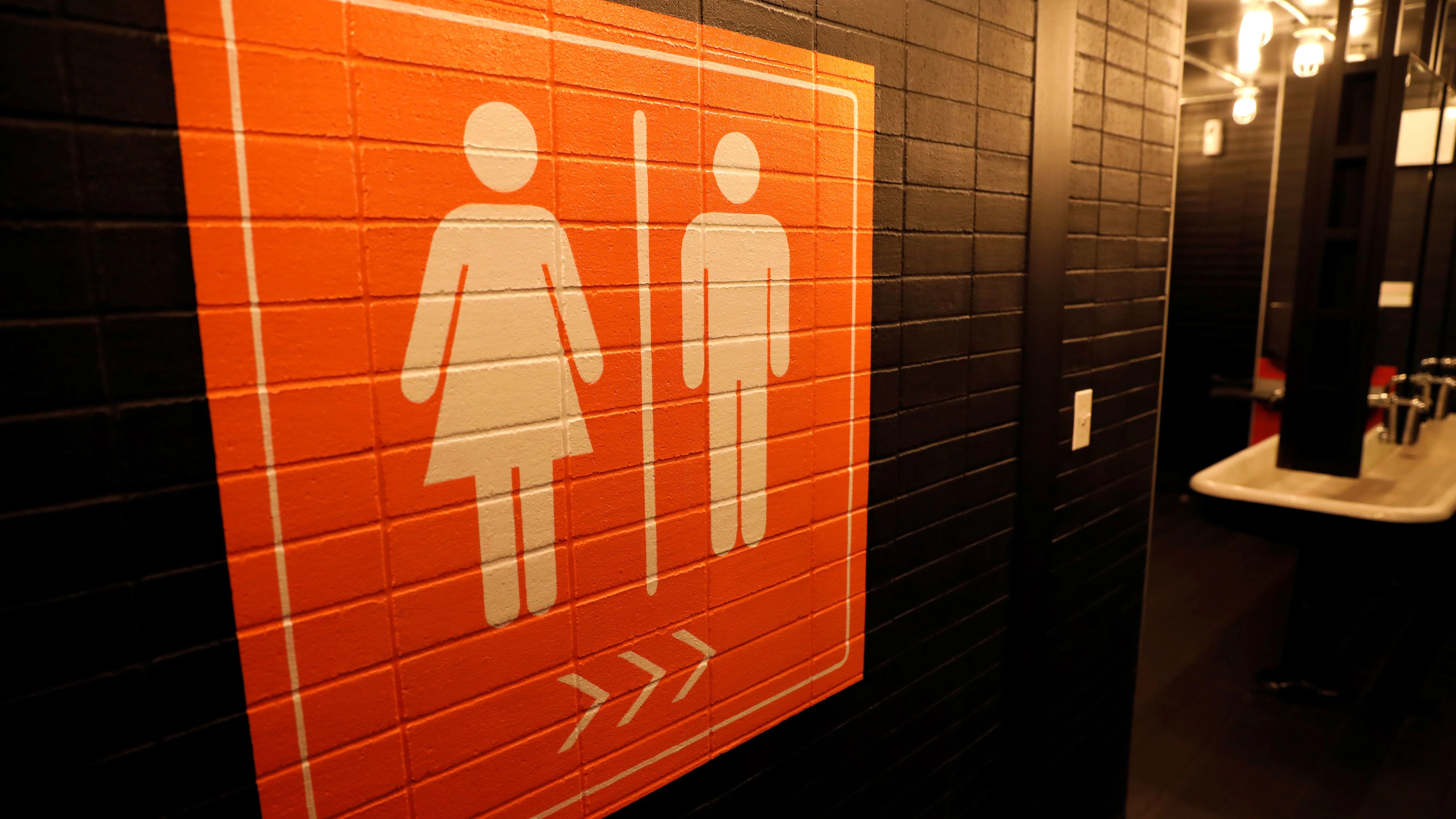 A sign is seen pointing to a gender neutral restroom in New York City, U.S., April 19, 2017. REUTERS/Mike Segar