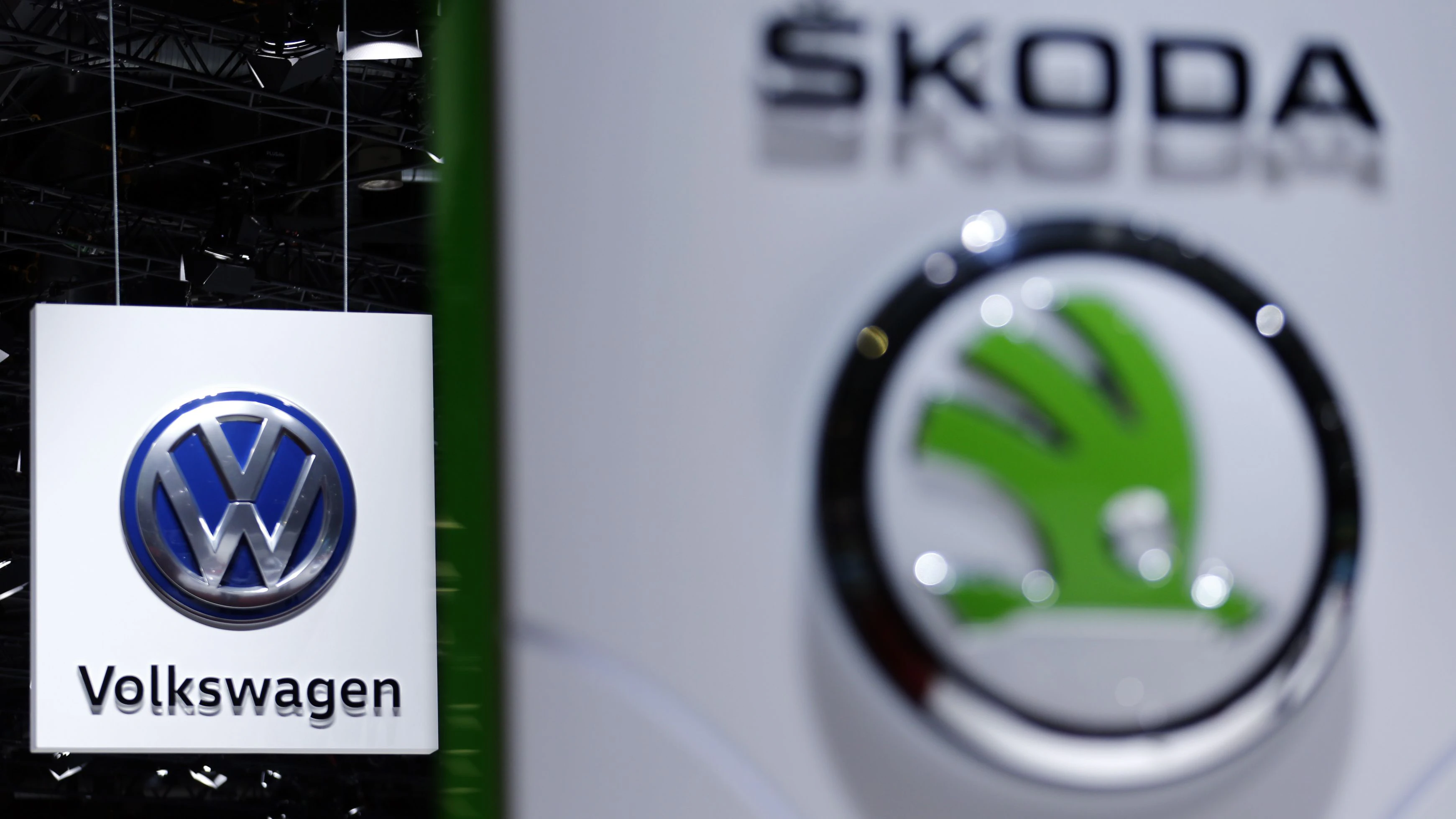 A Volkswagen (VW) logo is pictured next to a logo of Skoda during the second media day of the 86th International Motor Show in Geneva, Switzerland, March 2, 2016.   REUTERS/Denis Balibouse