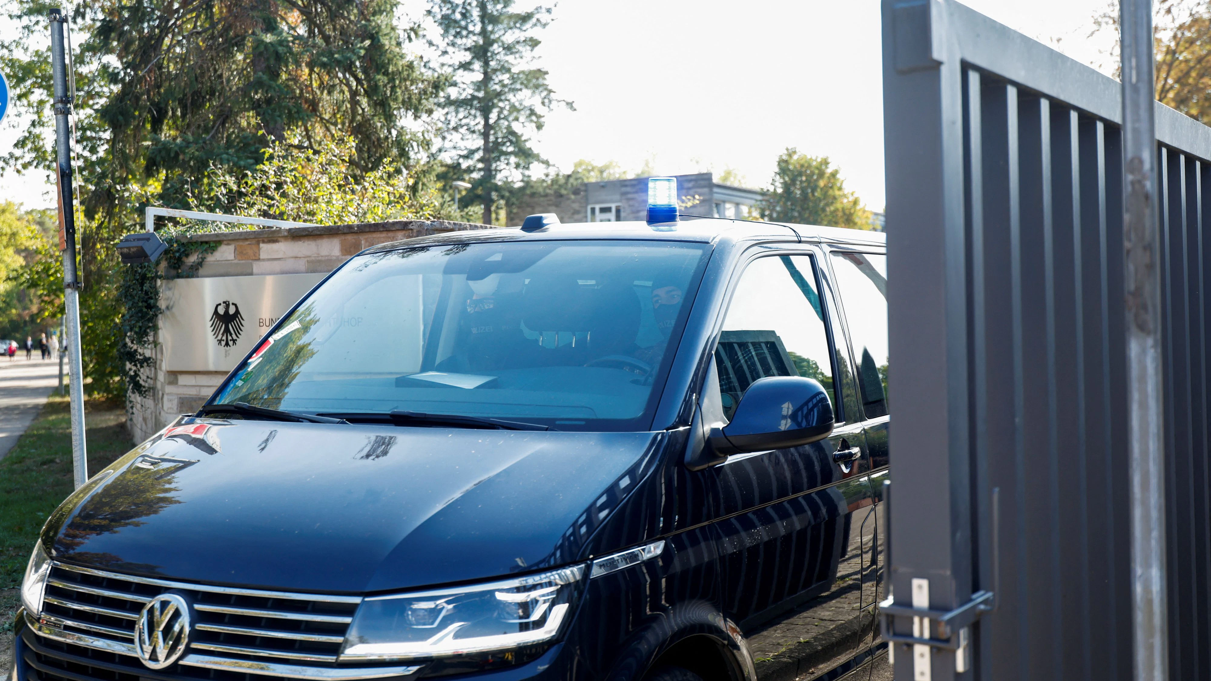 A vehicle believed to be carrying former German foreign intelligence chief August Hanning leaves the Federal Court of Justice after being detained on suspicion of attempted treason and obtaining state secrets, in Karlsruhe, Germany, October 7, 2026. REUTERS/Heiko Becker