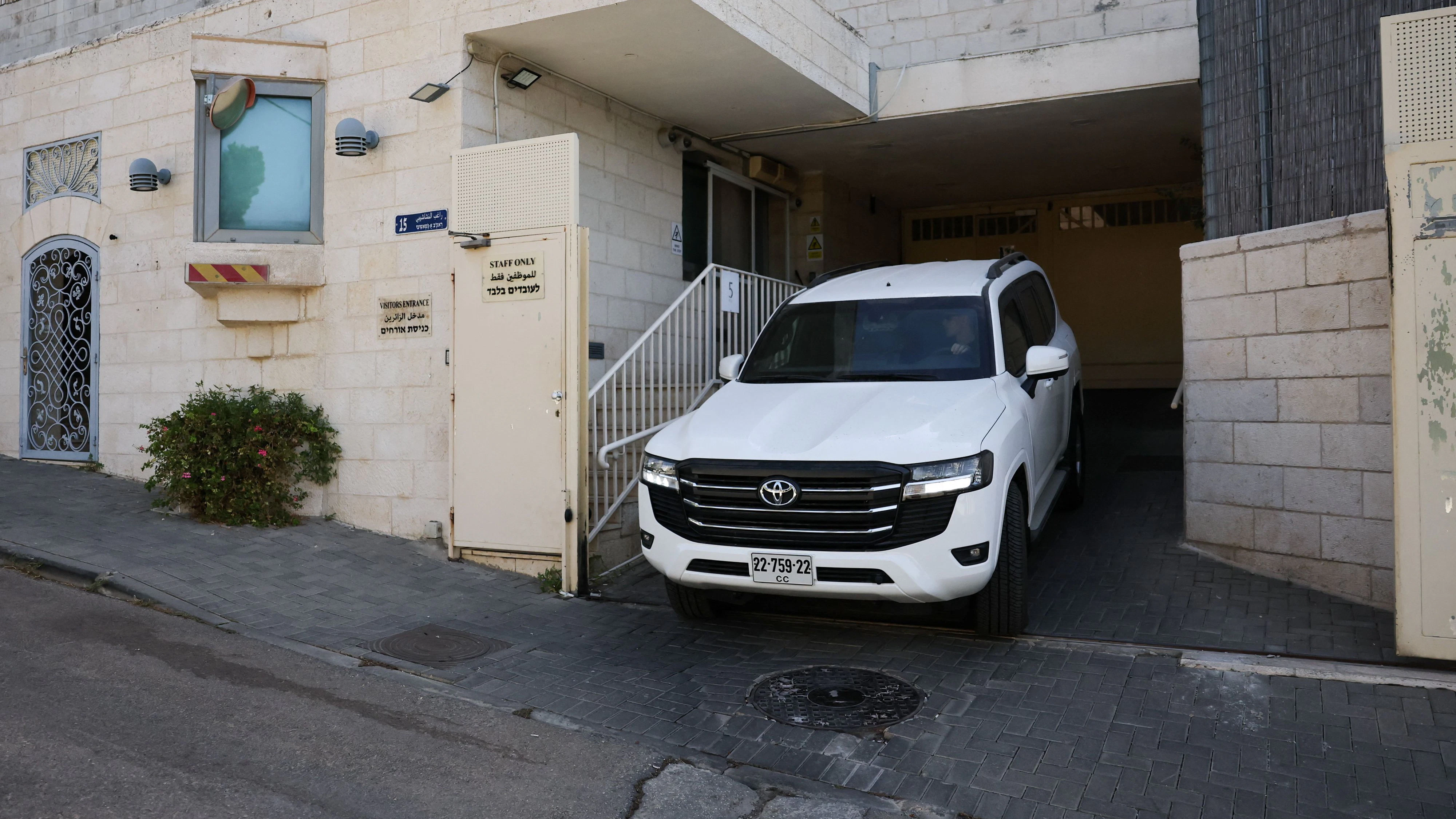 A diplomatic vehicle leaves the British consulate on the deadline set by Israel for its closure, following trade sanctions imposed by British Prime Minister Andy Burnham on Israeli settlements in the occupied West Bank, in East Jerusalem, October 8, 2026. REUTERS/Ammar Awad