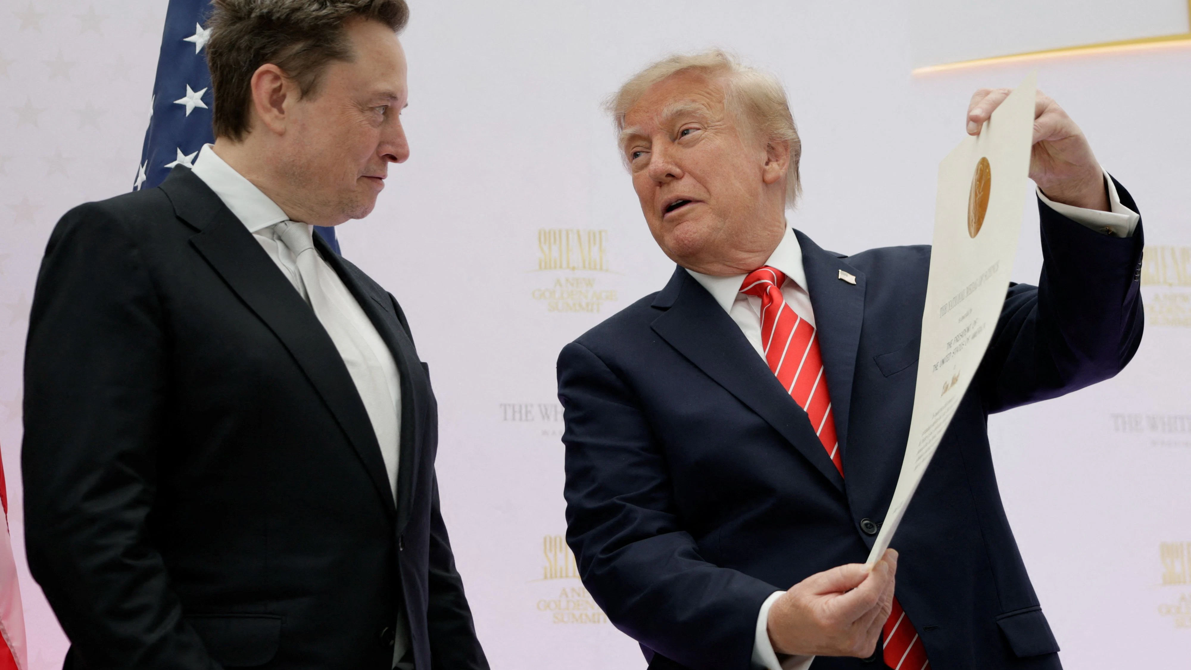 US President Donald Trump presents the National Medal of Science to Tesla and SpaceX CEO Elon Musk during the "A New Golden Age" summit at the US Institute of Peace, renamed The Donald J. Trump Institute of Peace by the Trump administration, in Washington, DC, US, October 8, 2026. REUTERS/Evan Vucci