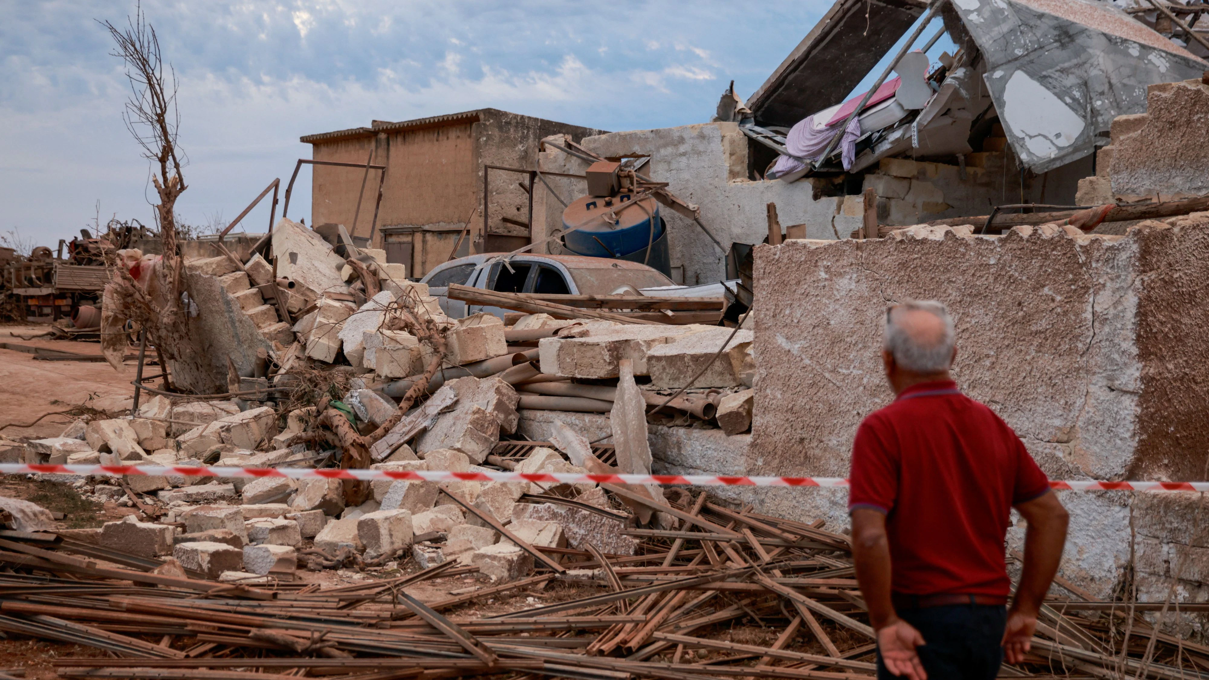A man surveys the damage to a partially collapsed building after a tornado struck Marsala, Sicily, Italy, October 9, 2026. REUTERS/Antonio Casci