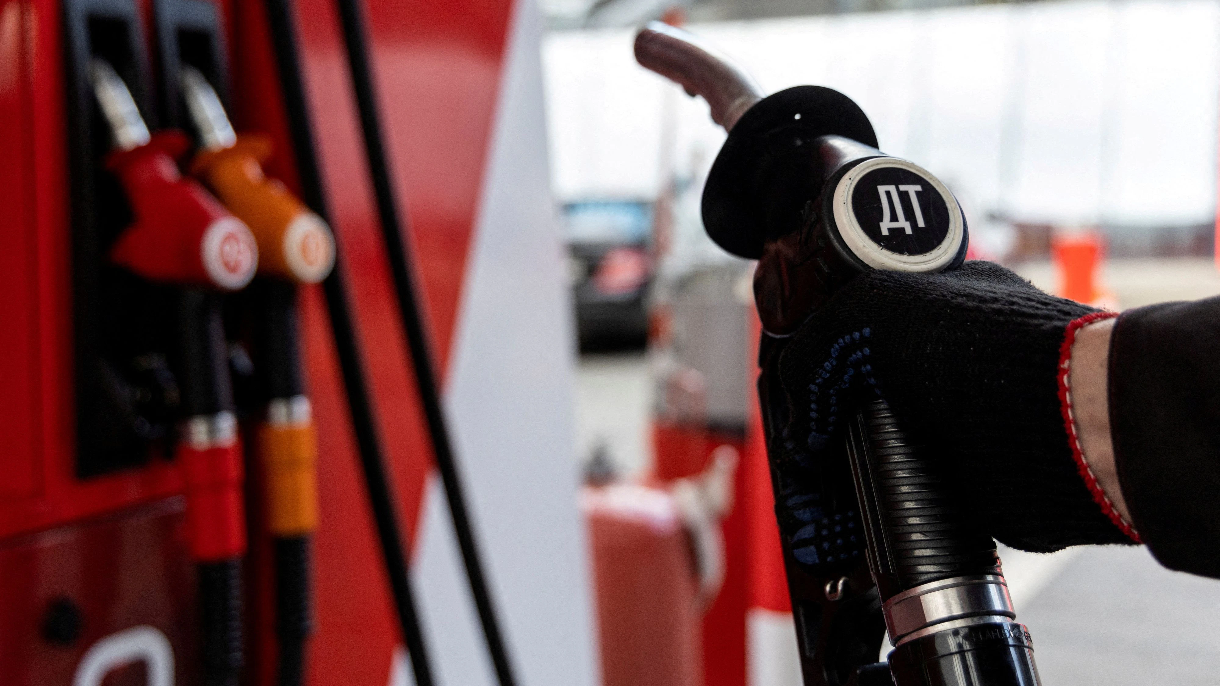 FILE PHOTO: An employee holds a diesel fuel pump nozzle at a petrol station of Neftmagistral company in Moscow, Russia, September 8, 2023. REUTERS/Maxim Shemetov/File Photo