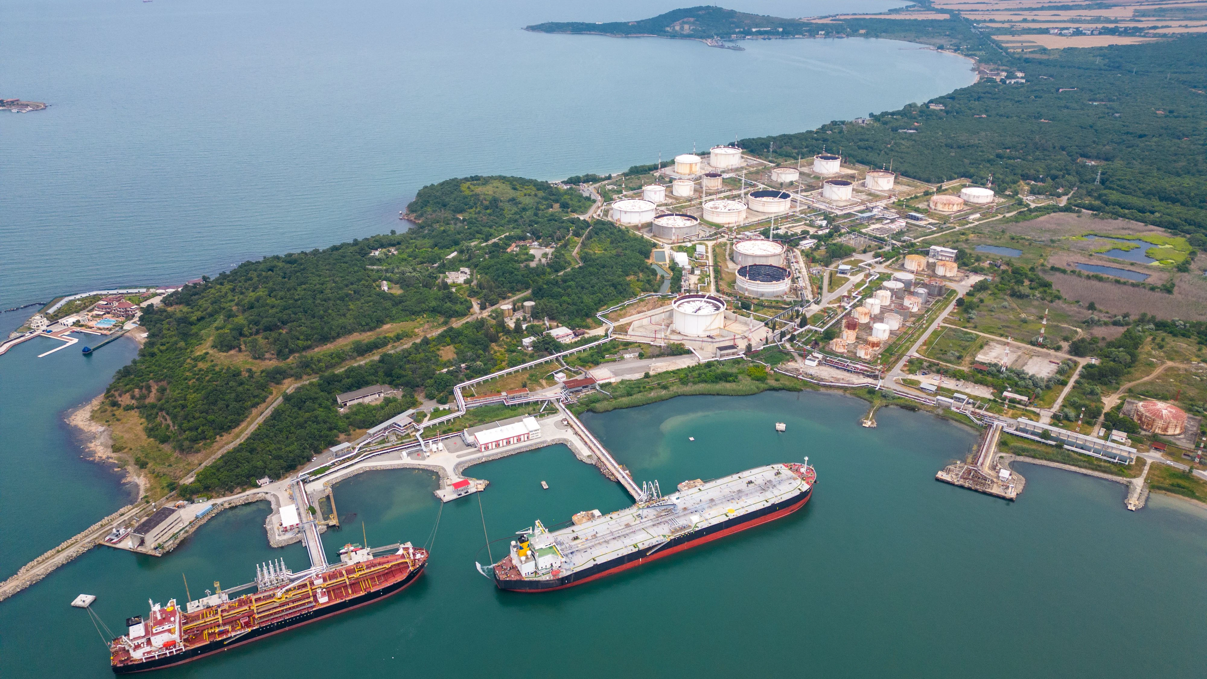 An aerial top view of two tankers near an oil storage facility on the shores of the Black Sea in Bulgaria, showcasing the maritime industry and coastal infrastructure   xkwx Aerial view tankers oil storage Black Sea Bulgaria maritime industry coastal infrastructure vessels ships storage facility petroleum maritime transport shipping oil tankers coastal scenery maritime trade energy logistics port coastal infrastructure offshore cargo maritime logistics maritime operations coastal economy seafaring tanker ships oil industry maritime hub coastal development oil transportation oil tanker tanker ship