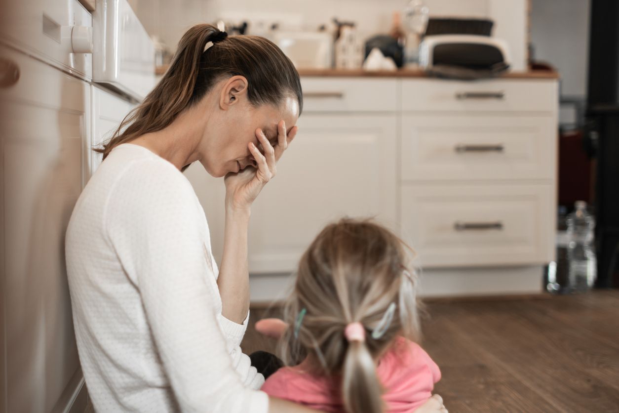 Tired stressed out mother with daughter.