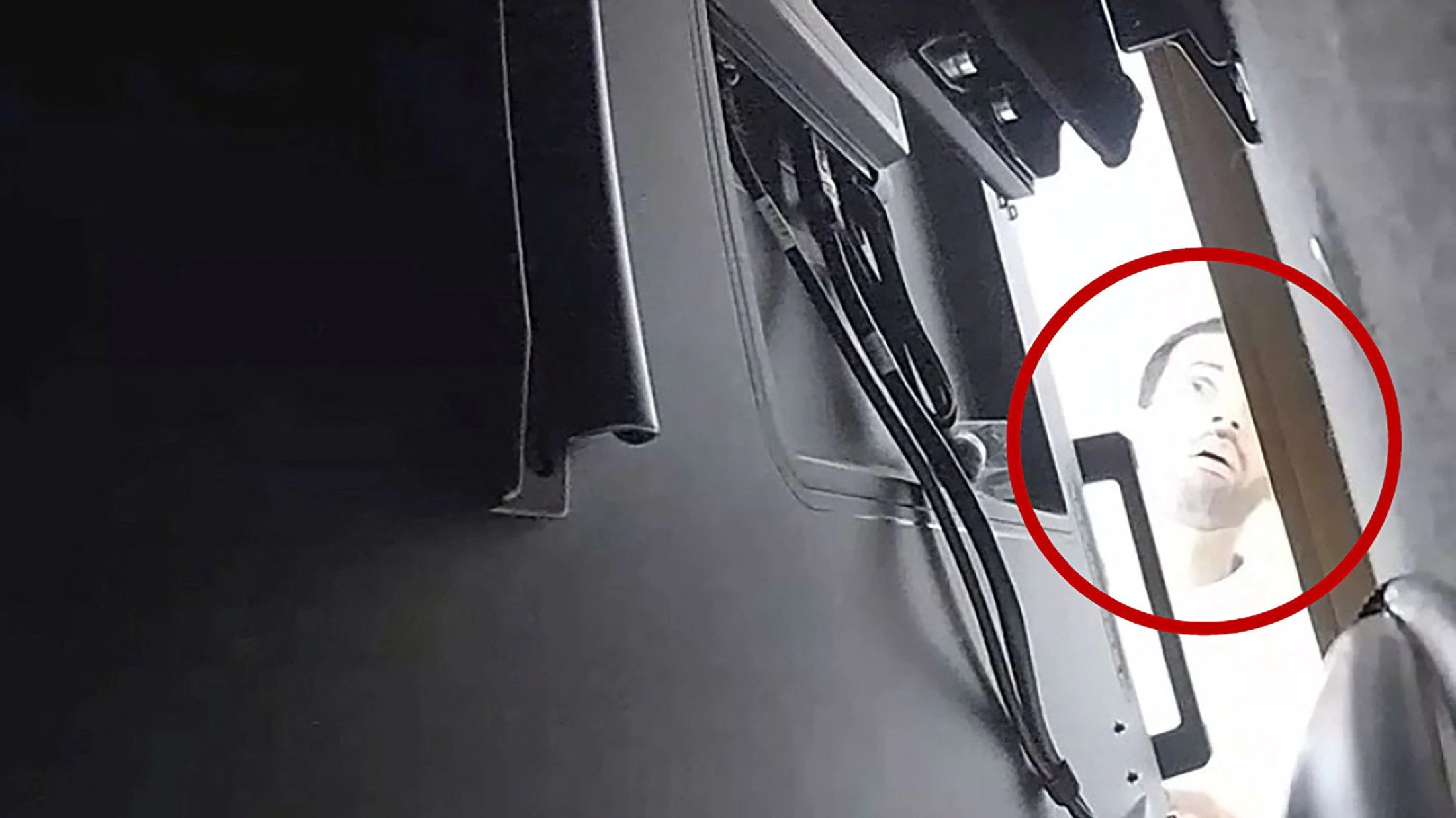 A man described as Abdulrahman Alfozan, a Saudi national employed as an OpenAI engineer, looks behind a television where a recording device had been placed at a conference room in OpenAI offices, in a still image from surveillance video included in a charging document after US federal agents the man and charged him with installing a hidden audio recording device, in San Francisco, California, US, October 5, 2026.   Department of Justice/Handout via REUTERS. 
THIS IMAGE HAS BEEN SUPPLIED BY A THIRD PARTY