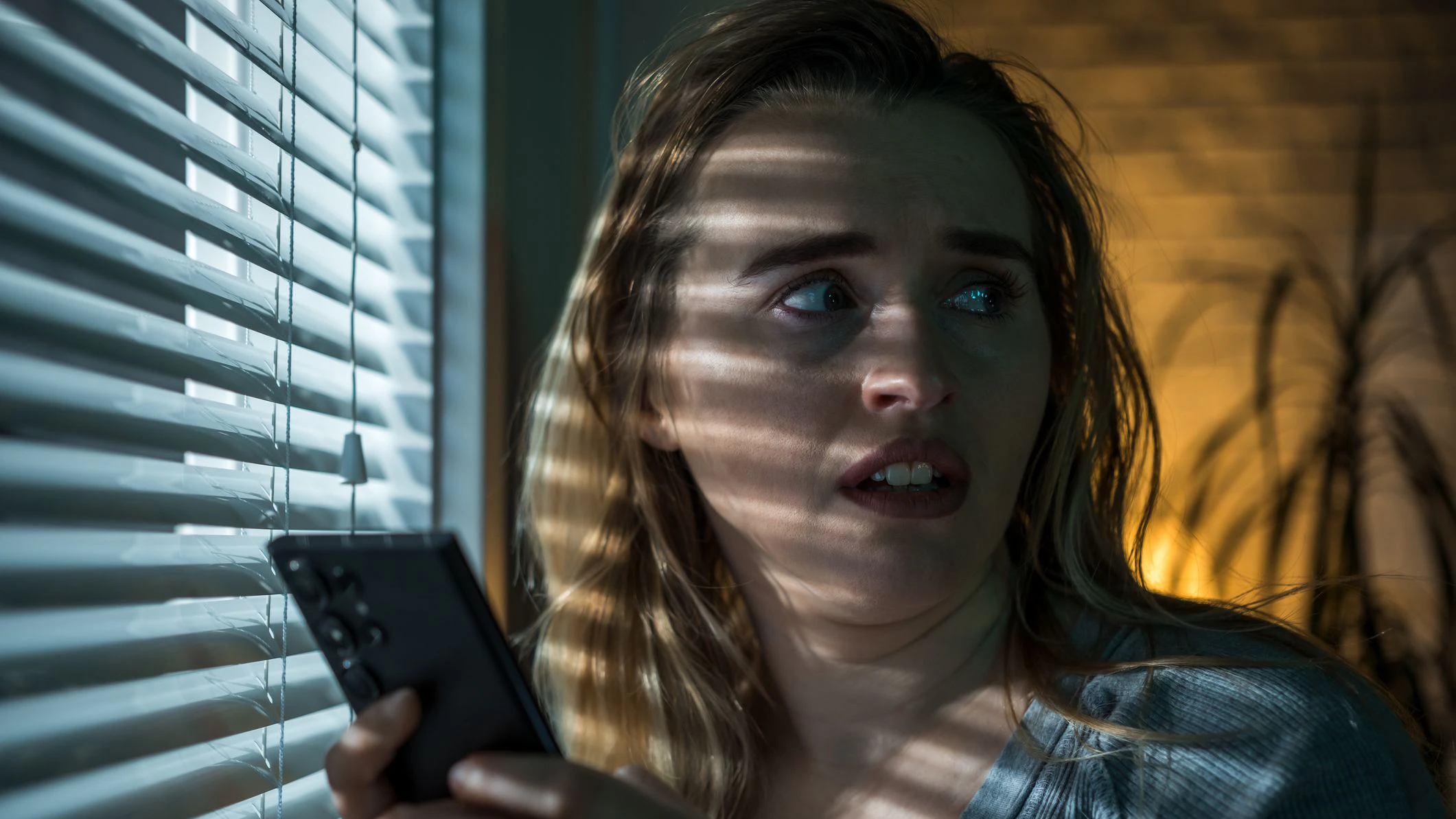 Scared woman in living room