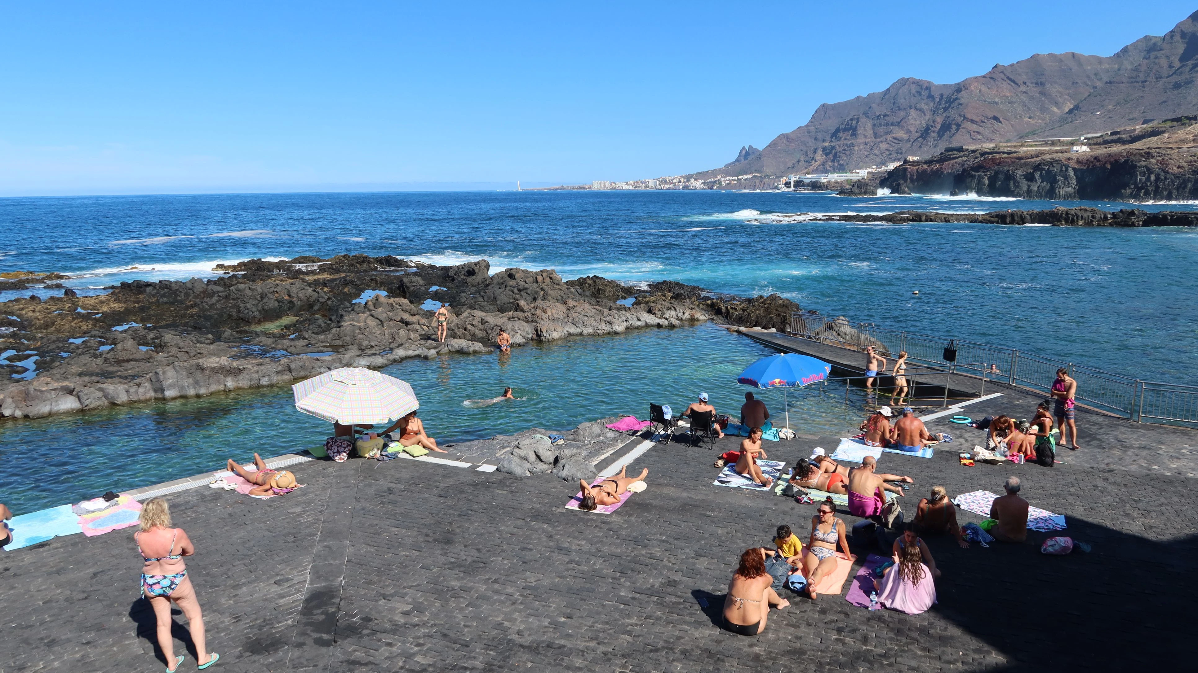 Jover, Tenerife, Spain, November 1, 2025: Numerous tourists enjoy the sea and sun at the natural pool of Jover in the Atlantic Ocean, Tenerife, Spain
