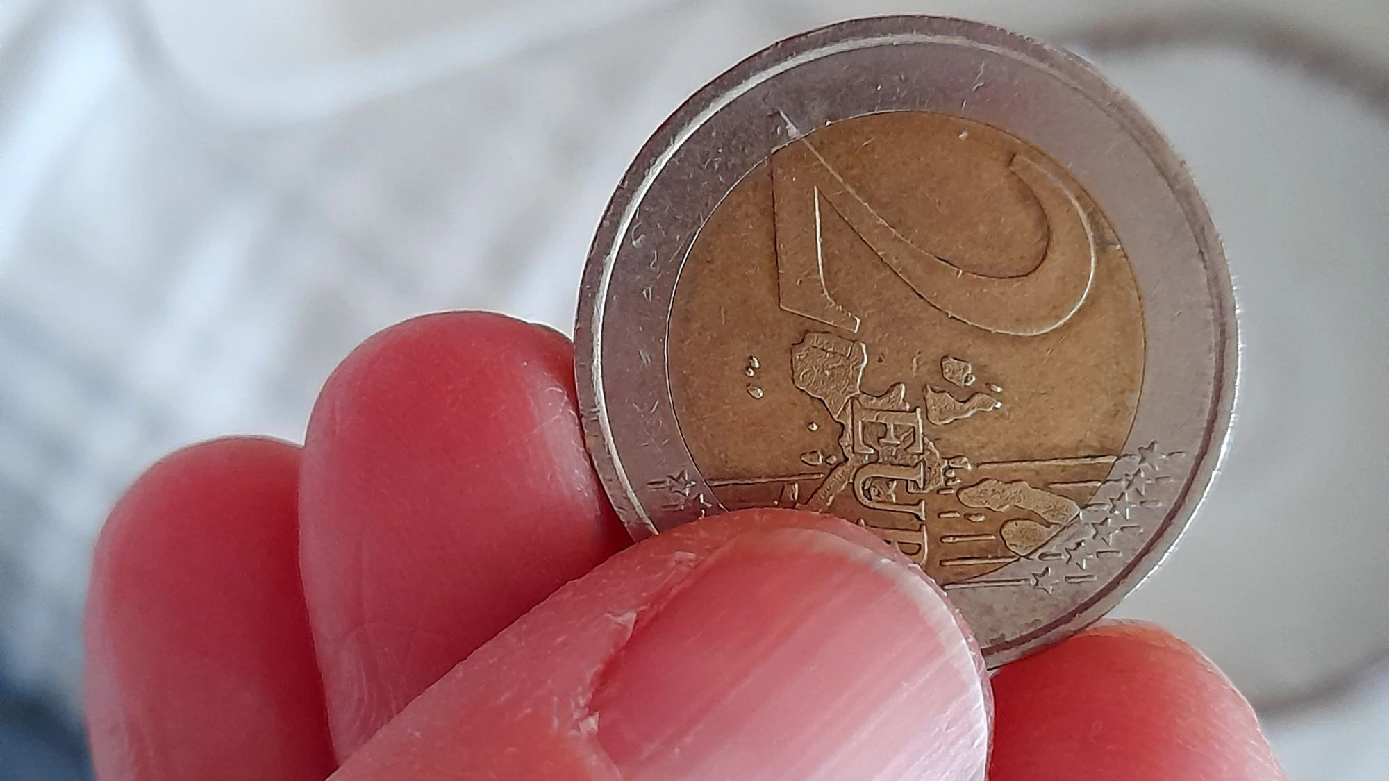 2 euro coin in hand close up