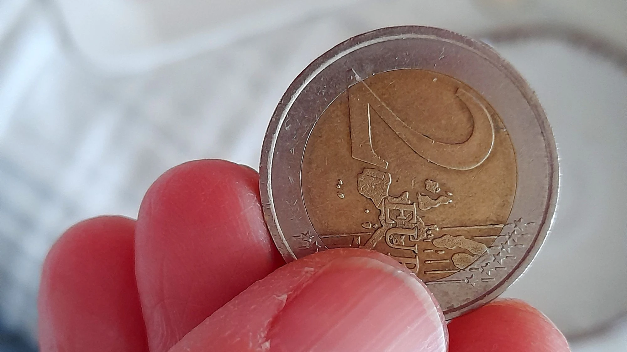 2 euro coin in hand close up