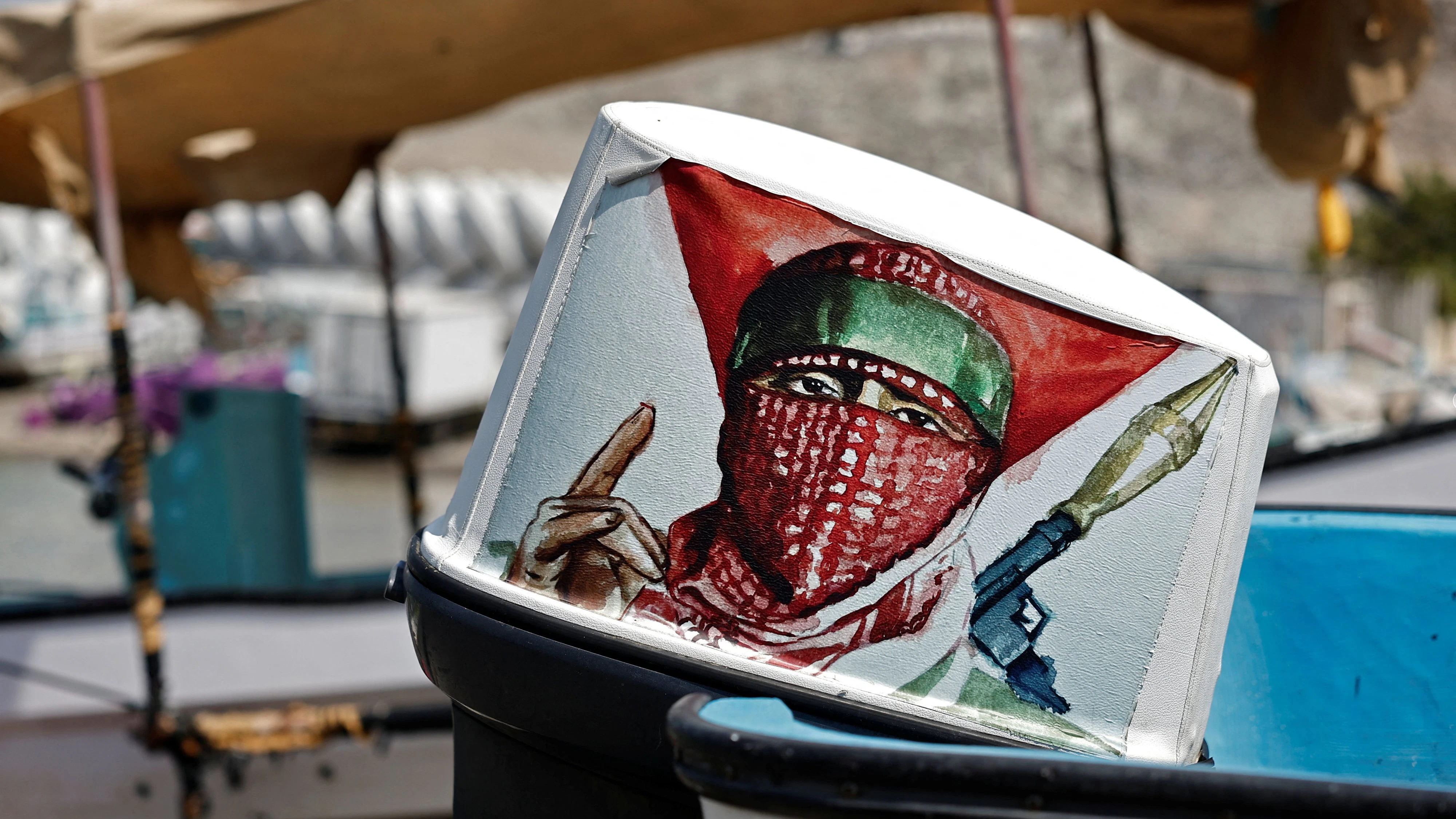 A drawing representing Hamas's military is stuck on the engine of a boat on Haramil Beach, amid the U.S.-Israeli conflict with Iran, in Muscat, Oman, March 6, 2026. REUTERS/Benoit Tessier