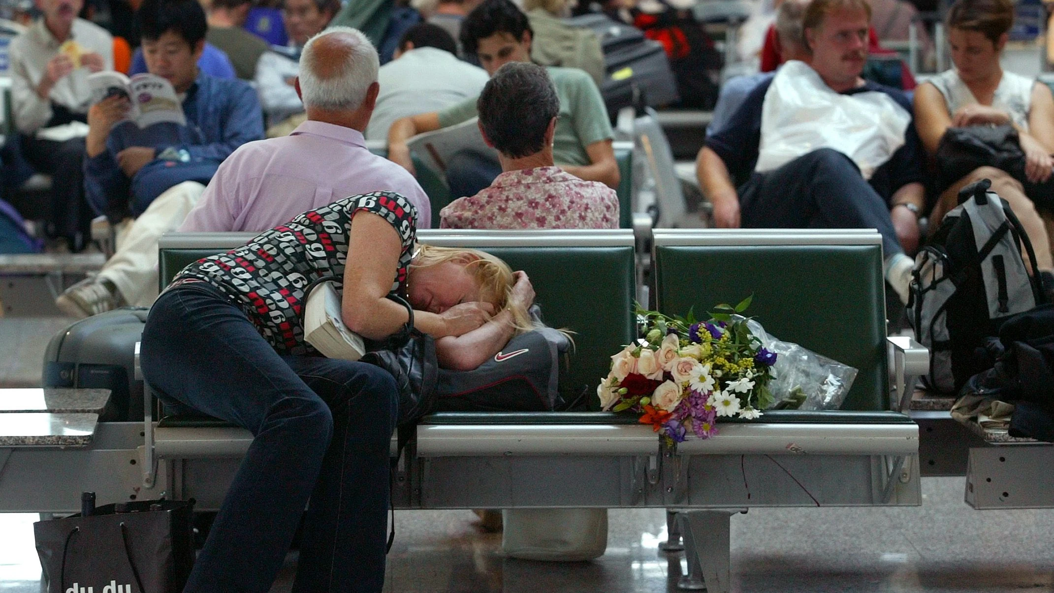 A woman sleeps on her luggage as she waits at Rome's Fiumicino airport
September 28, 2003. Due to a power cut which hit a large part of Italy
in the early hours of Sunday morning many international and national
flights have been cancelled or delayed.

REUTERS/Alessia Pierdomenico