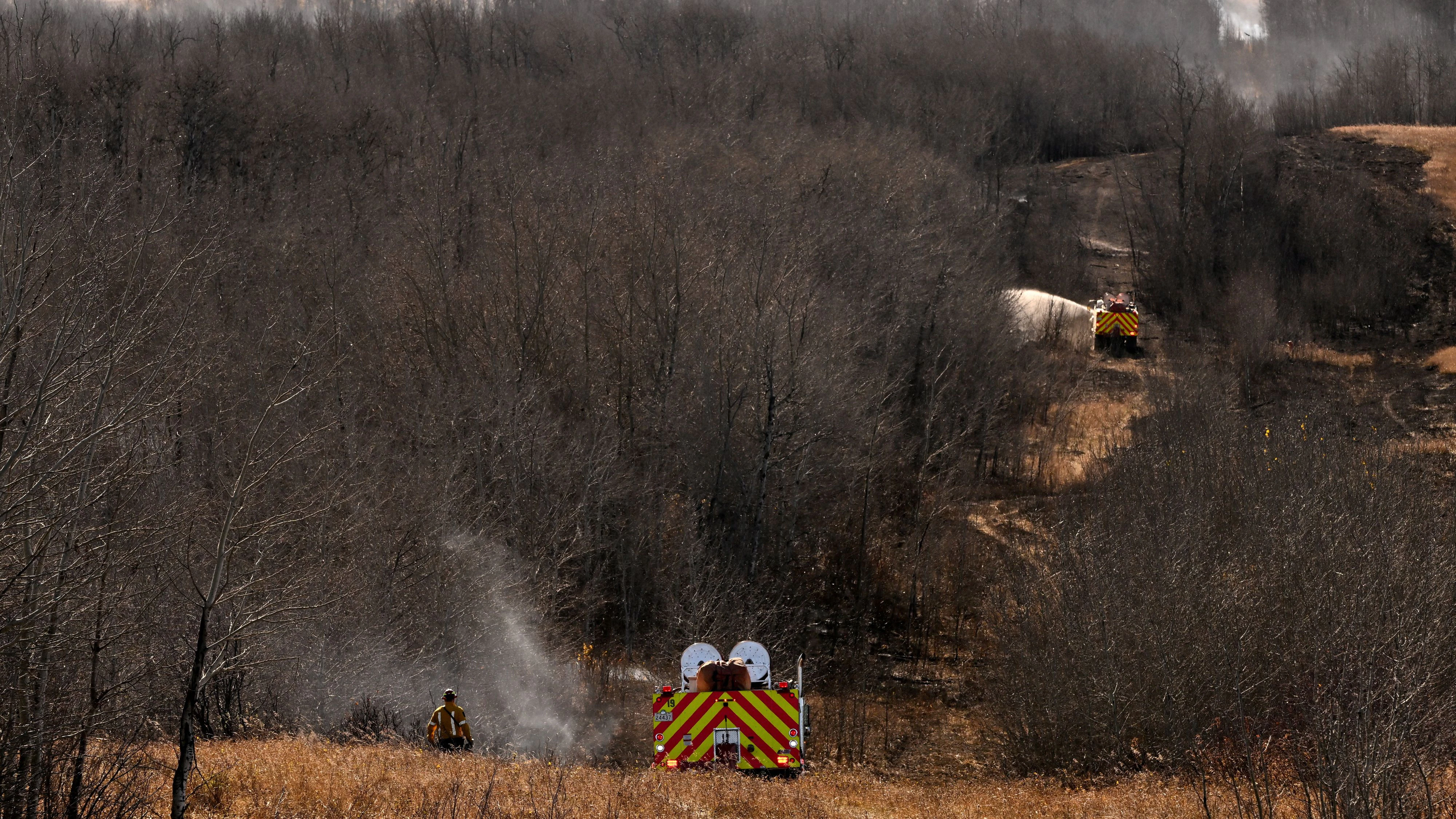 Firefighters continue to work on hot spots, the day after a serious incident that resulted in a fire caused deaths and injuâries, in Wainwright, Alberta, Canada, October 18, 2026. REUTERS/Jennifer Gauthier