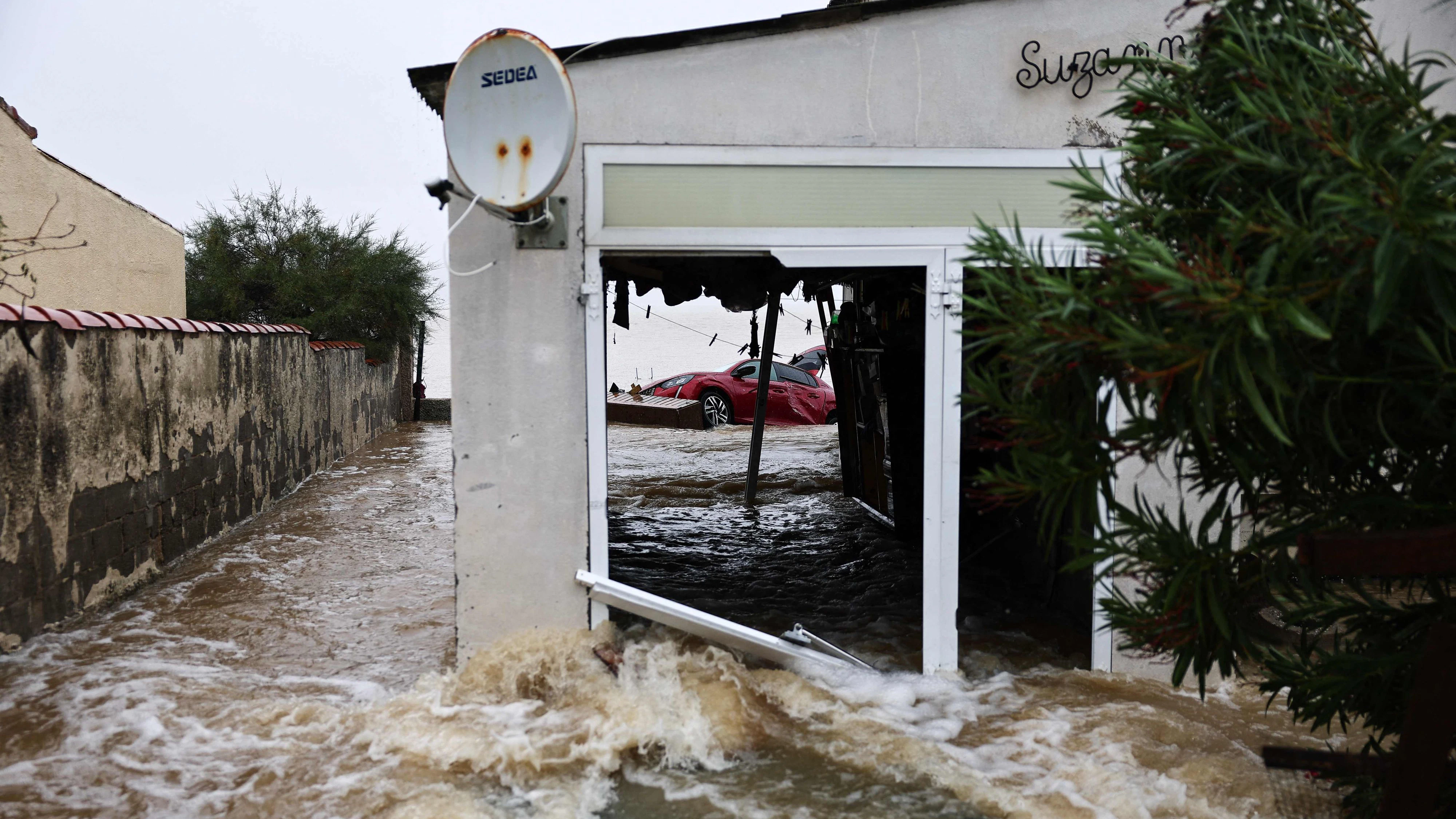 This photograph shows a damaged car and a flooded house in a residential area following severe rainfall in Saint-Mitre-les-Remparts, near Marseille, south-eastern France on October 20, 2026. Heavy rainfall that began on October 19, 2026 caused significant flooding in several watercourses, from the Herault department to the Bouches-du-Rhone in south-eastern France, overnight necessitating the evacuation or securing of dozens of people. (Photo by Thibaud MORITZ / AFP)