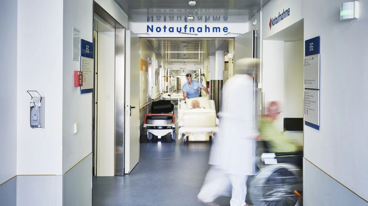 Emergency admission entrance hospital with doctor wheelchair and patient in motion blur on the corridor and nurse with hospital bed