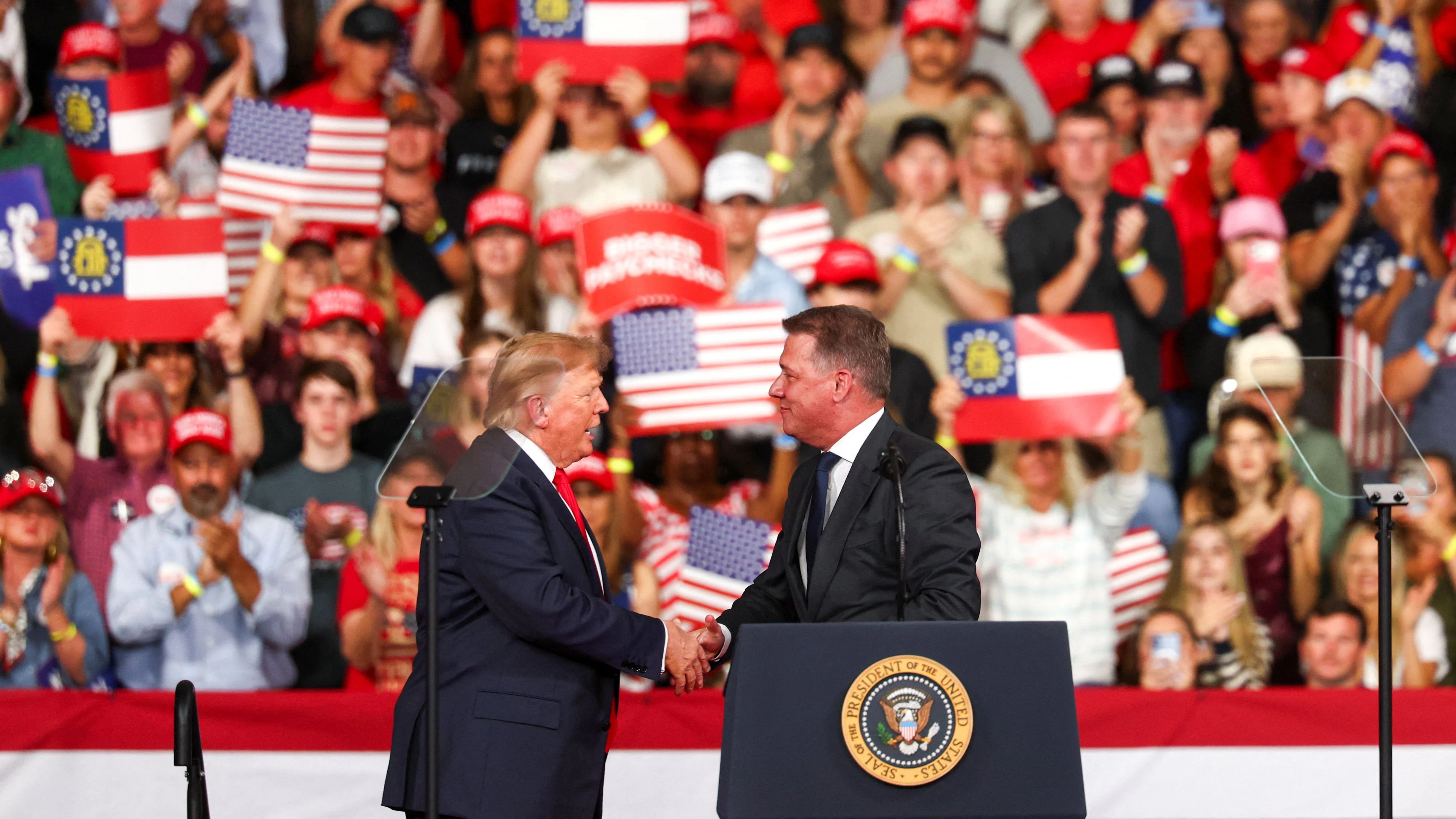 US President Donald Trump greets Gernot Dollner, CEO of Audi AG, during a rally at Guardian Centers in Perry, Georgia, US, October 24, 2026. REUTERS/Edgar Su