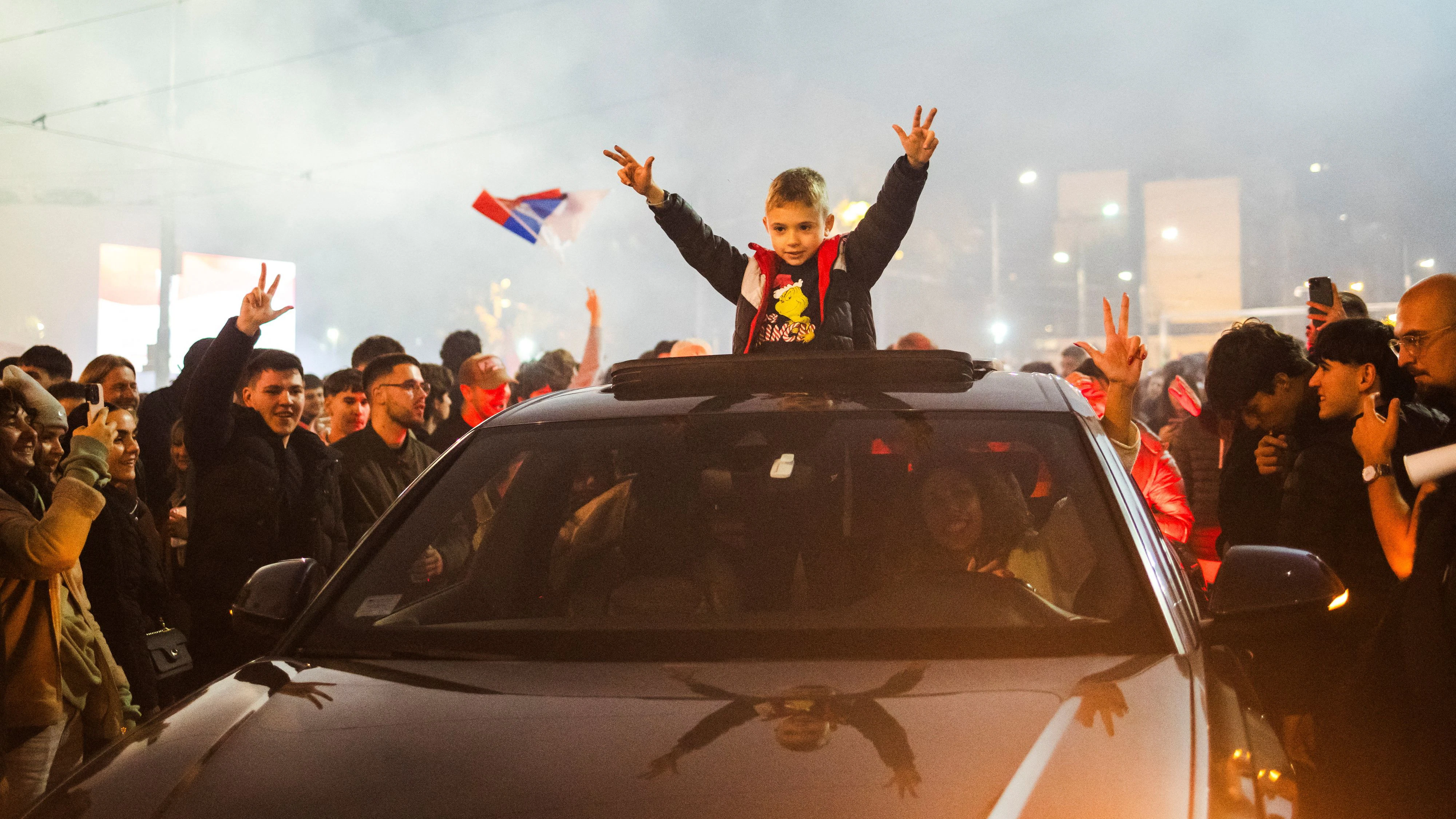 A child gestures from a vehicle as supporters of the electoral list "Student List - Students Win" celebrate after Aleksandar Vucic, Serbian Progressive Party (SNS) prime ministerial candidate, conceded defeat in the parliamentary election in Belgrade, Serbia, October 25, 2026. REUTERS/Marko Djurica     TPX IMAGES OF THE DAY     