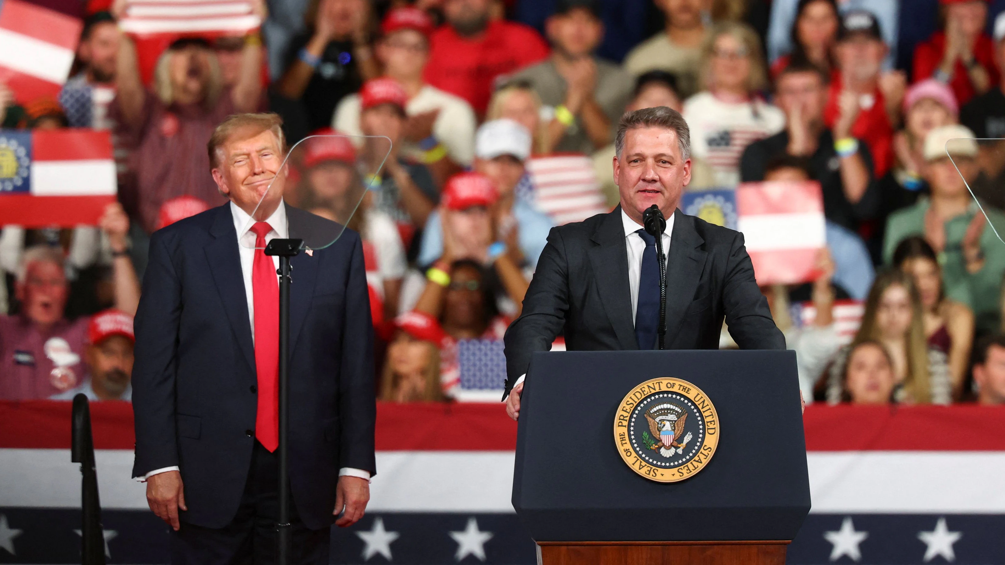 Gernot Dollner, CEO of Audi AG, speaks next to US President Donald Trump during a rally at Guardian Centers in Perry, Georgia, US, October 24, 2026. REUTERS/Edgar Su
