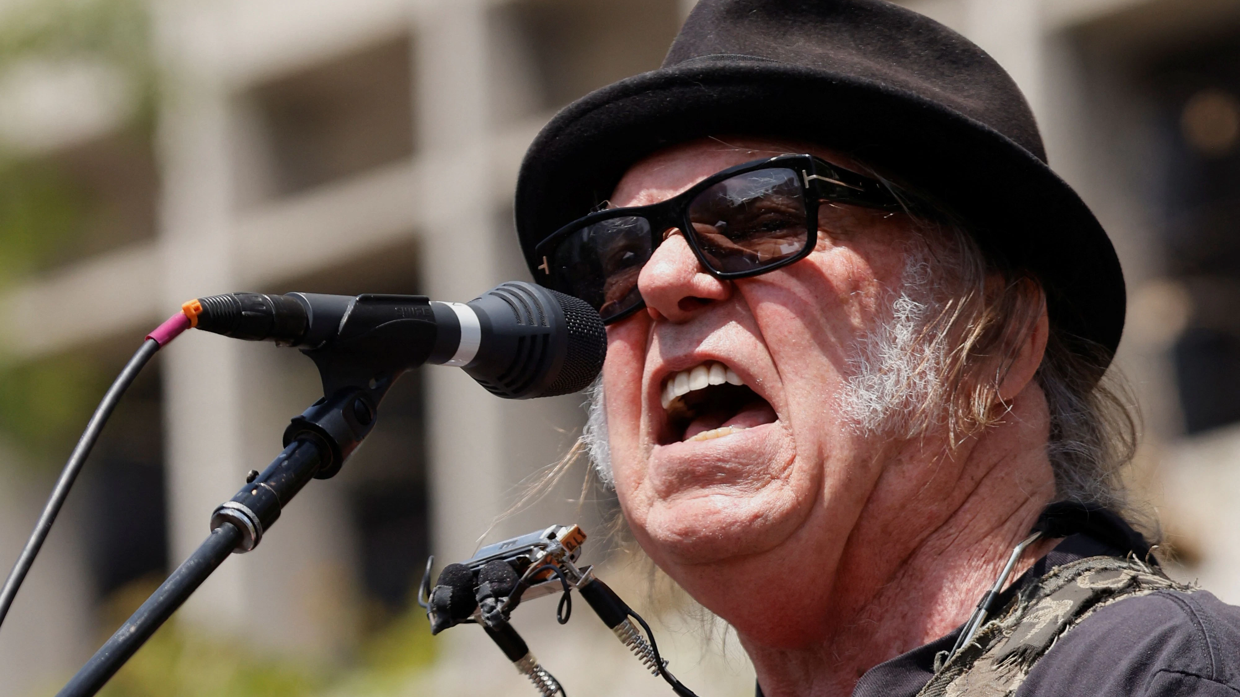Neil Young performs during a rally held by U.S. Senator Bernie Sanders (I-VT) and U.S. Representative Alexandria Ocasio-Cortez (D-NY) in Los Angeles, California, U.S., April 12, 2025. REUTERS/Carlin Stiehl