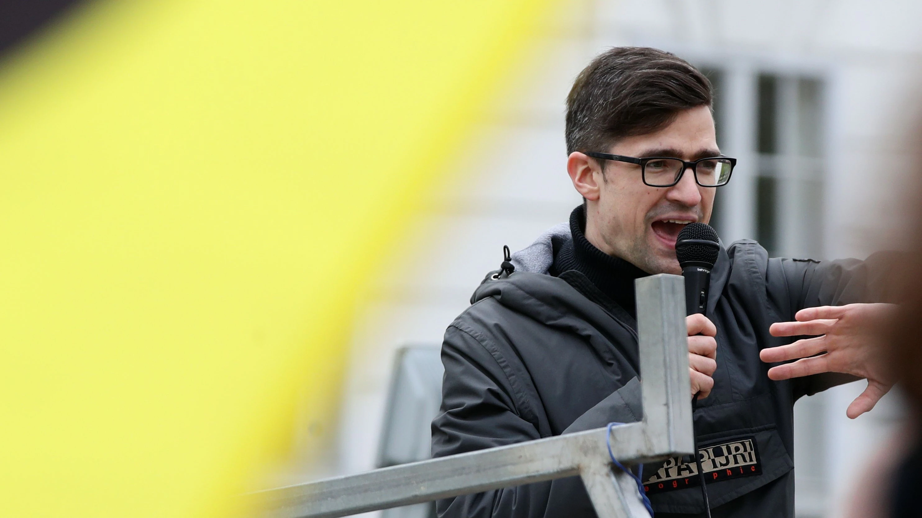 Leader of Austria's Identitarian Movement Martin Sellner speaks during a protest against a police raid at his house, outside the Justice Ministry in Vienna, Austria, April 13, 2019. REUTERS/Lisi Niesner