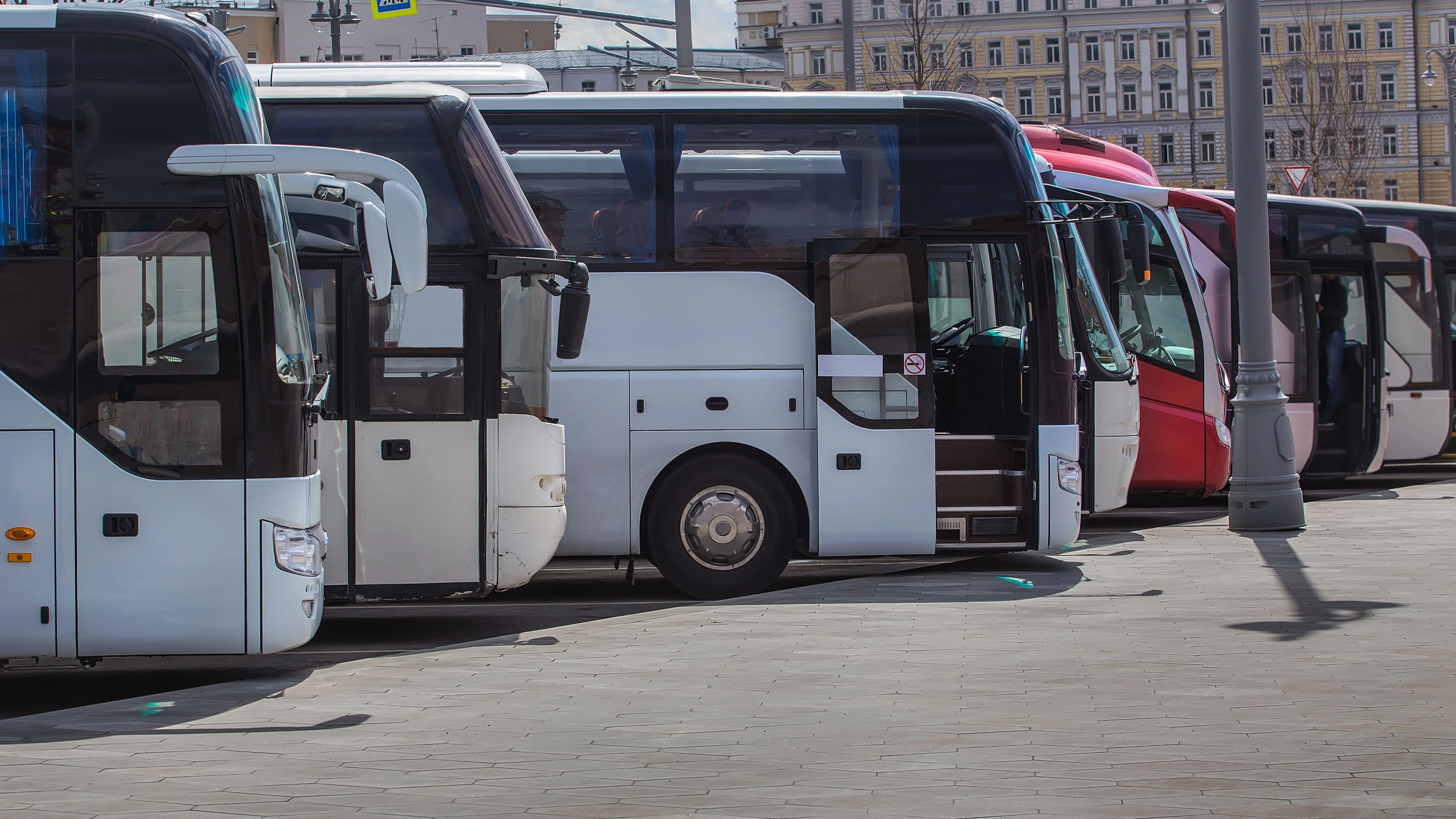 tourist buses on parking on the background of cloudy sky